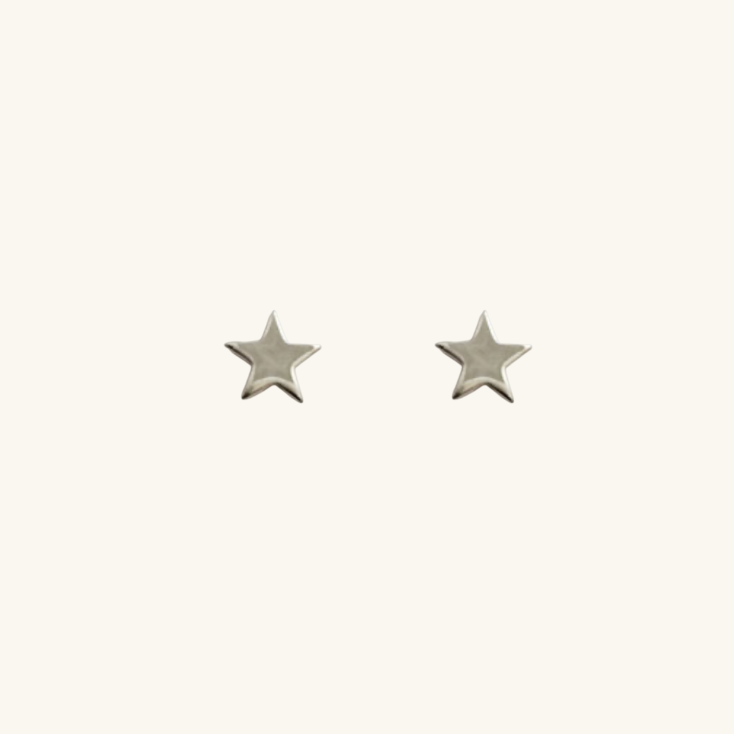 Silver Star-shaped earrings on a white background