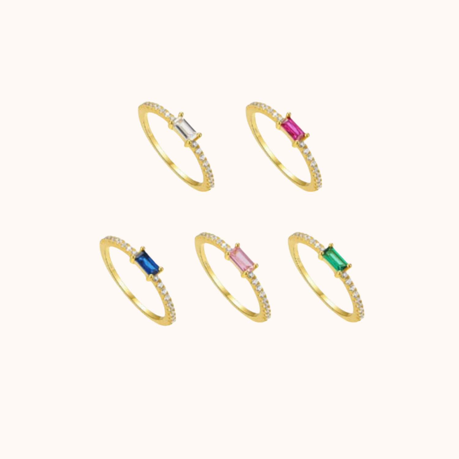 Set of five gold rings with colorful gemstones on a white background