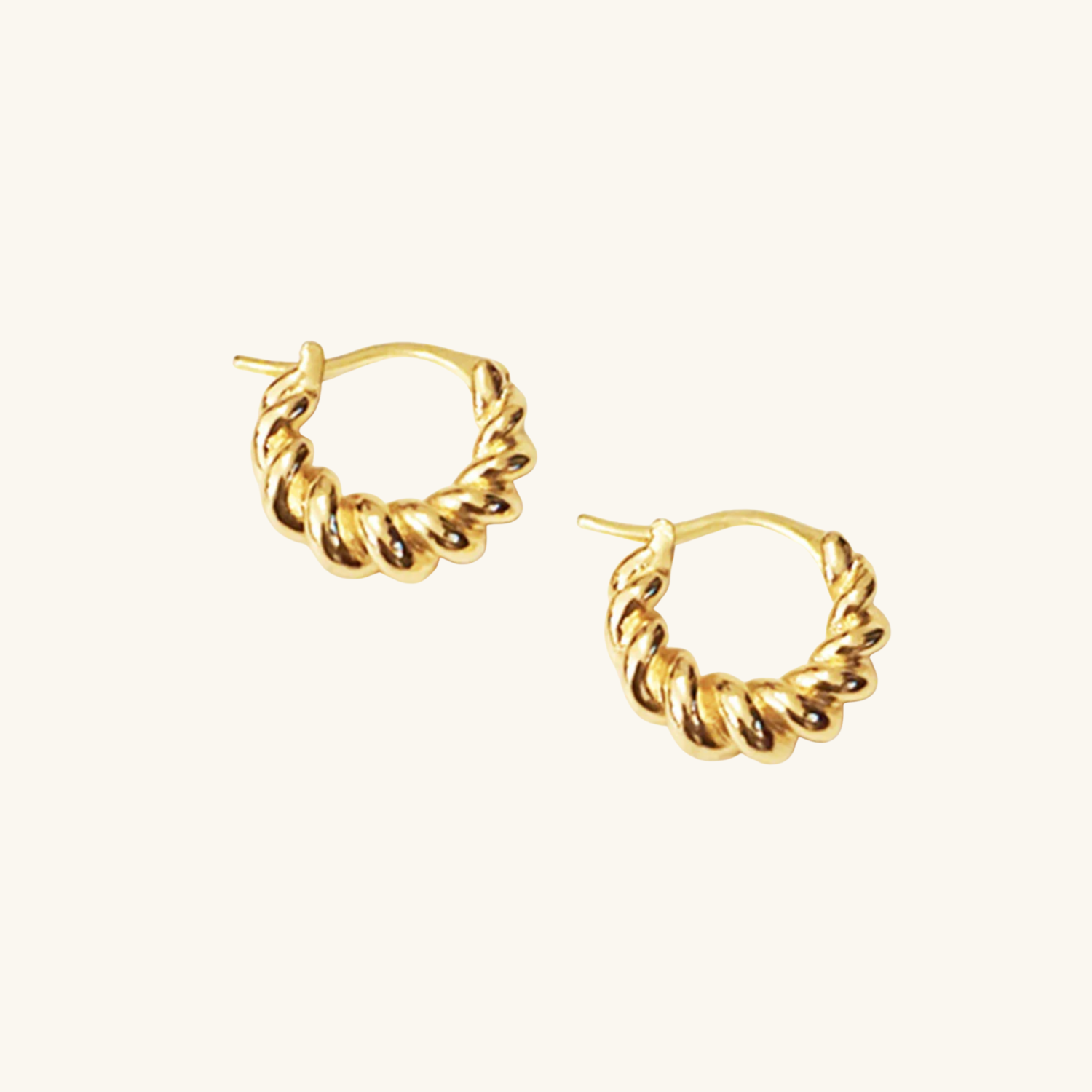 Flat lay Croissant_Dome_Earrings on cream background