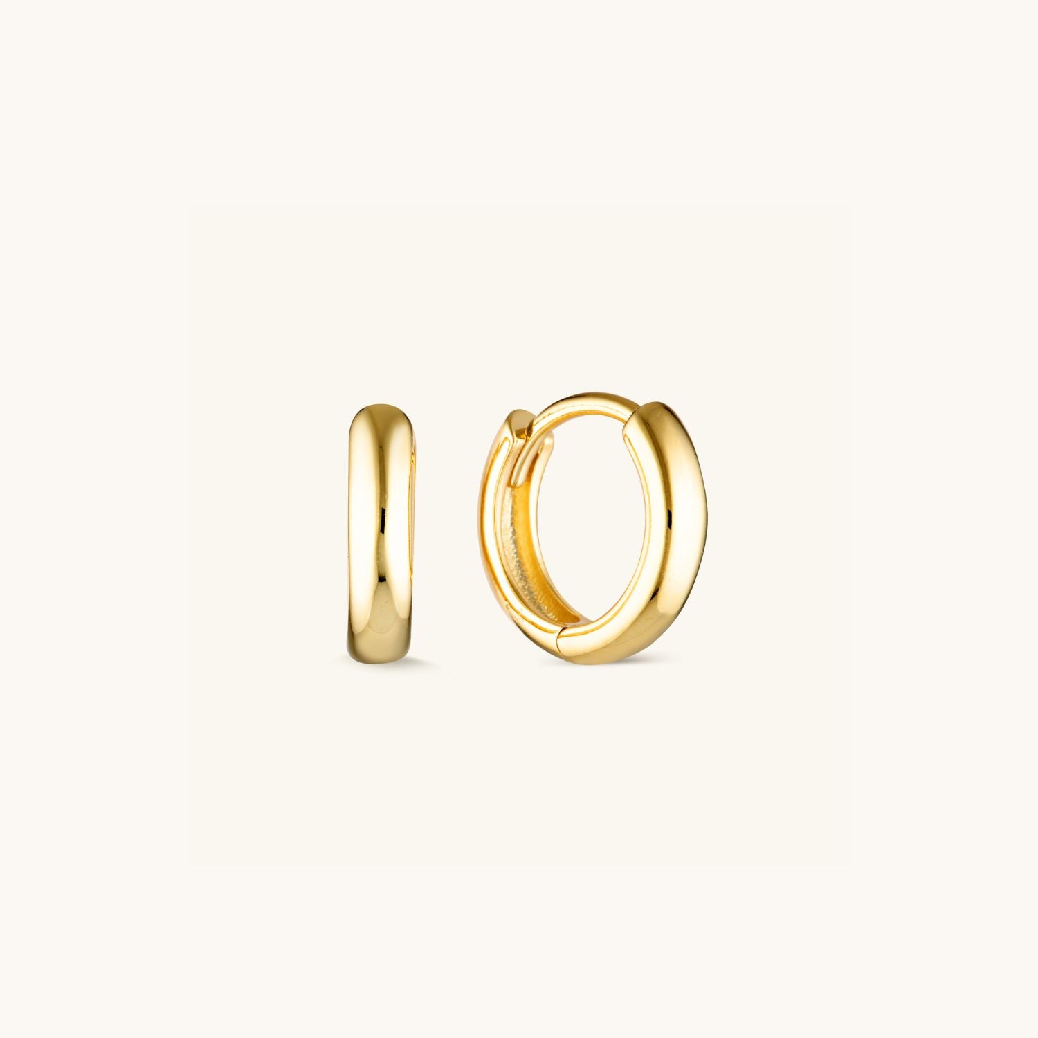 Essential Huggie Earrings with a smooth, minimalist design in sterling silver or gold-plated. A timeless everyday staple for stacking or solo wear.
