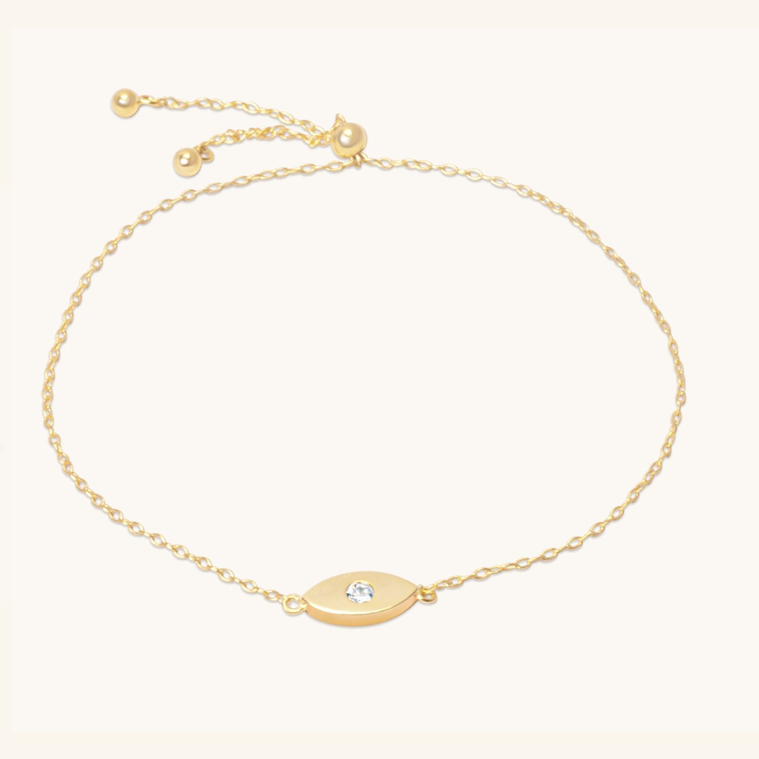 Flat lay of evil eye bracelet with adjustable bolo clasp, styled on neutral background.
