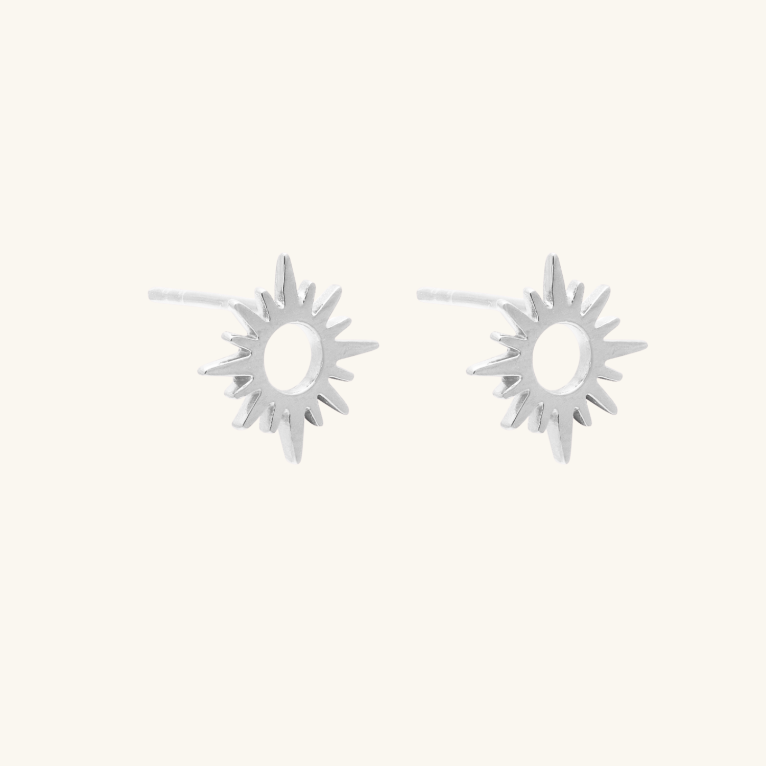 Silver Flare earrings shown on cream background