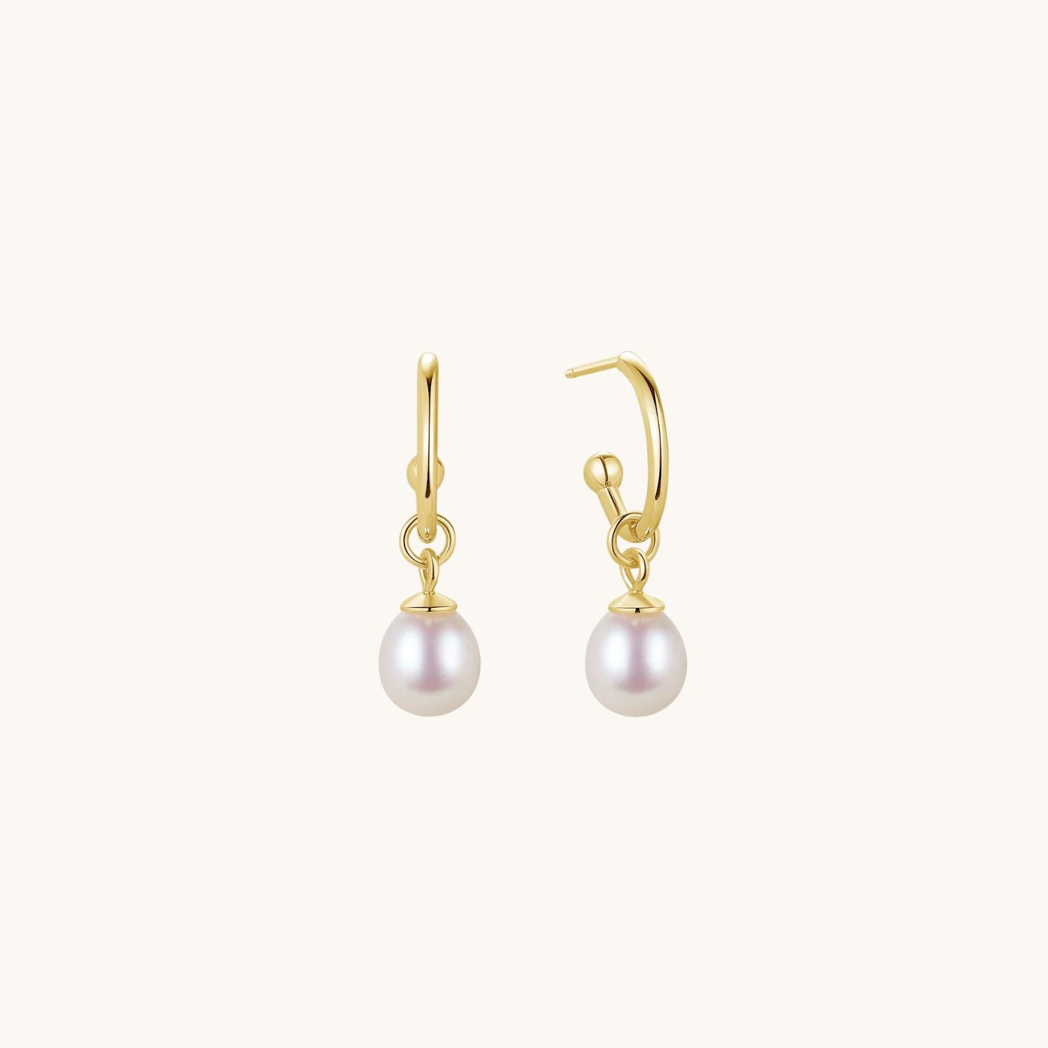 Gold freshwater pearl drop earrings featuring elegant, natural pearls on a delicate gold-plated setting. A timeless and sophisticated accessory