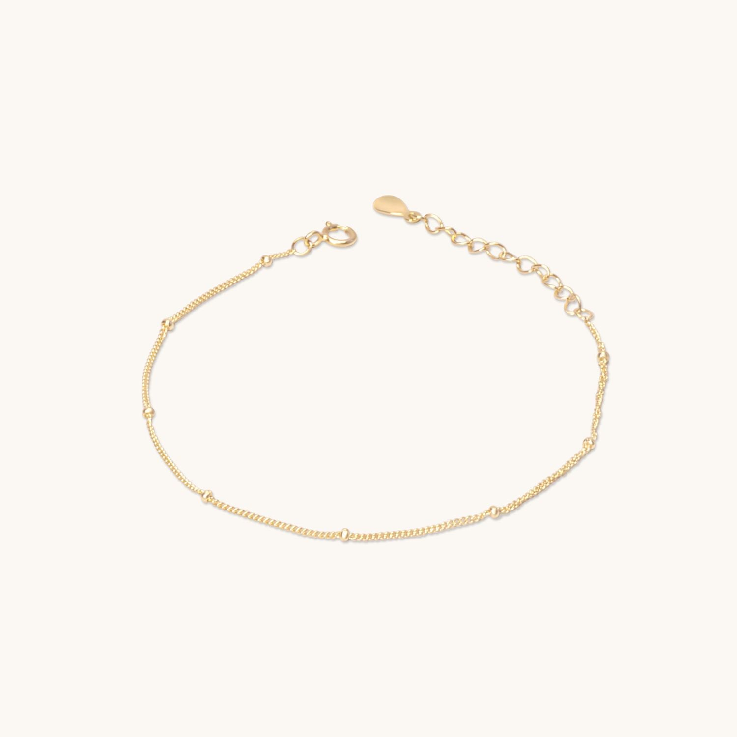 Gold satellite chain bracelet featuring dainty bead accents, adding a subtle shimmer. A versatile piece for everyday elegance or layering