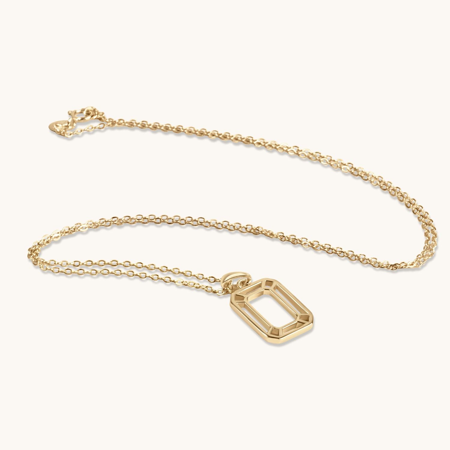 Gold interlocking box pendant necklace with a modern geometric design on a delicate chain. Stylish, timeless, and versatile.