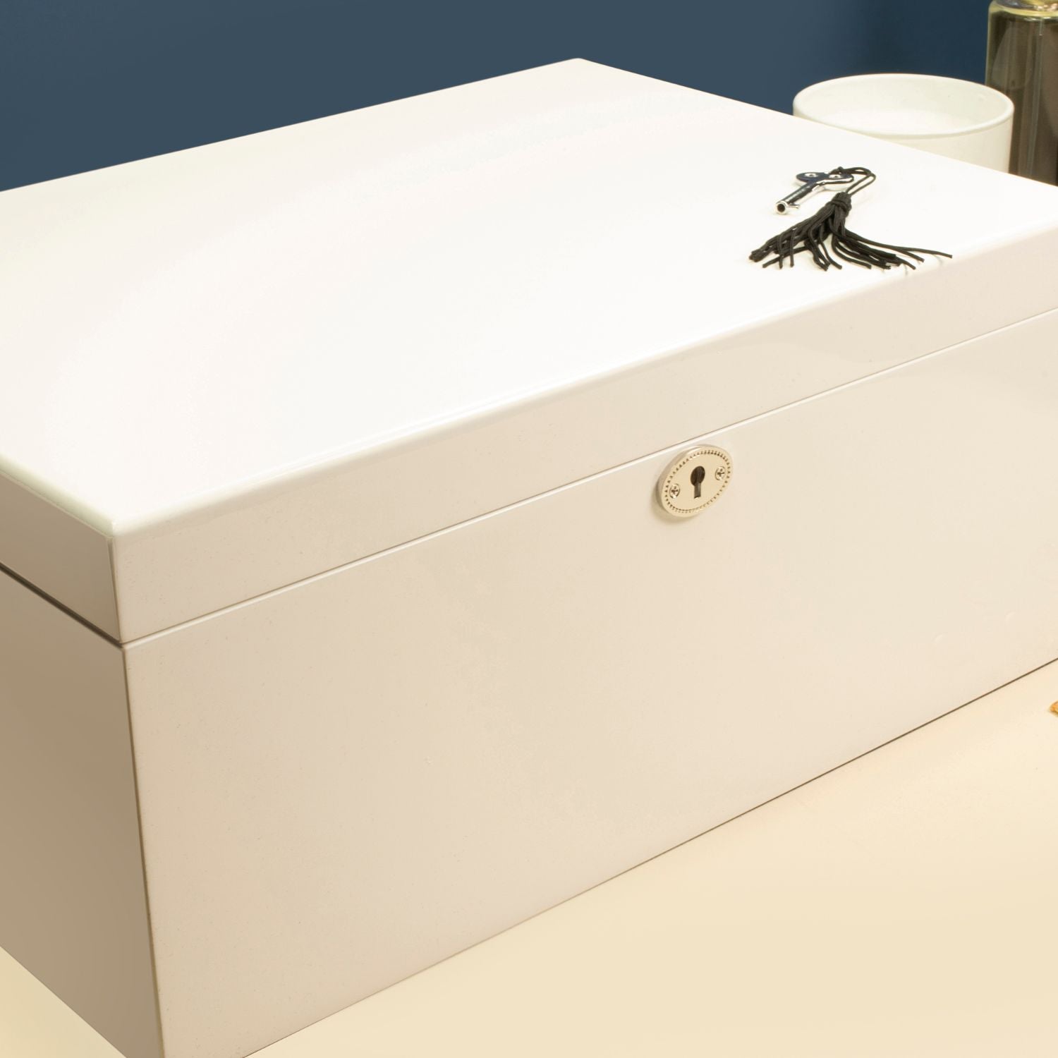 Sleek white multi-compartment jewellery box with a minimalist design, shown closed.