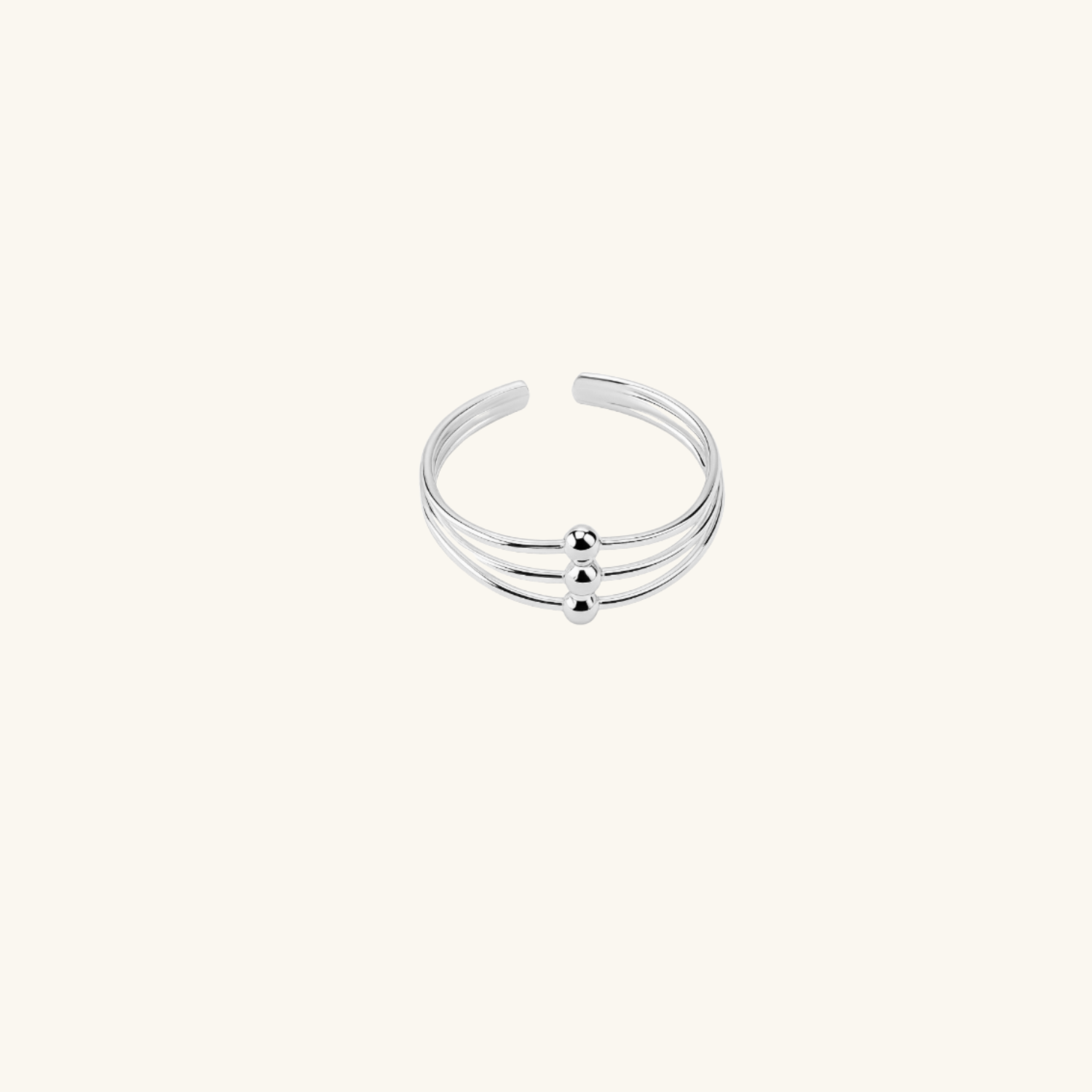 Silver toe ring with three horizontal bands on a white background