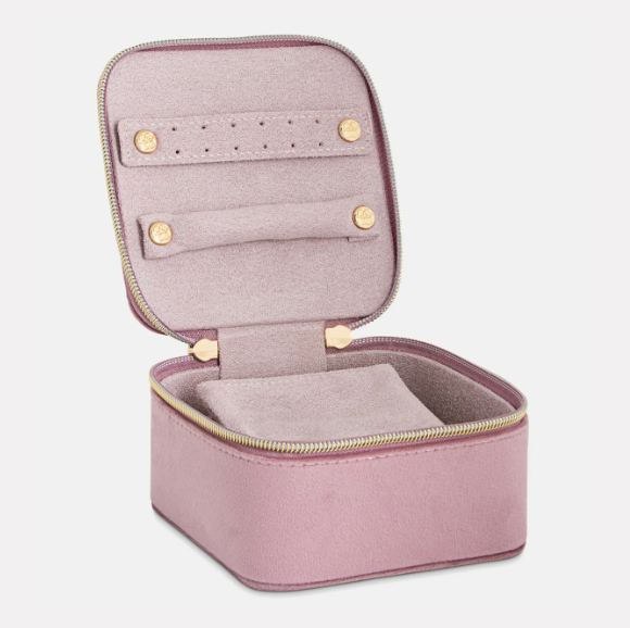 Soft pink velvet jewellery cube open, displaying multiple storage sections for rings, earrings, and necklaces