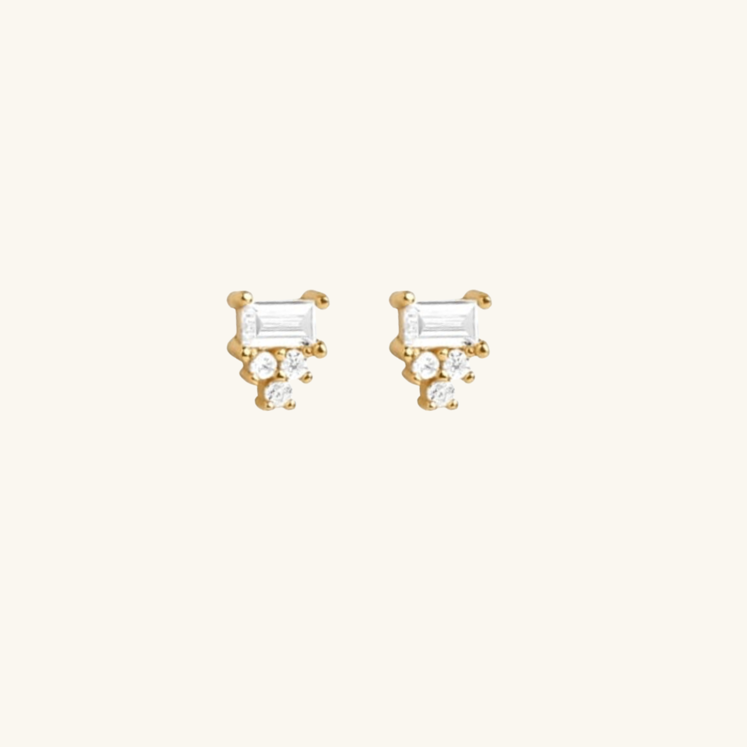 Gold earrings with clear Cubic Zirconia on a white background