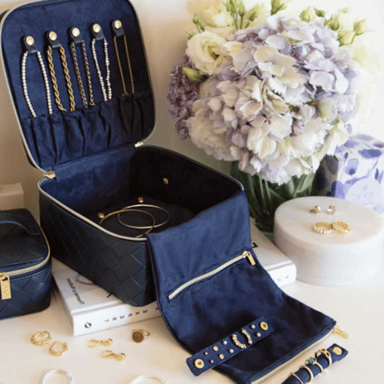 Navy woven patterned jewellery case with jewellery inside, showcasing organized storage compartments