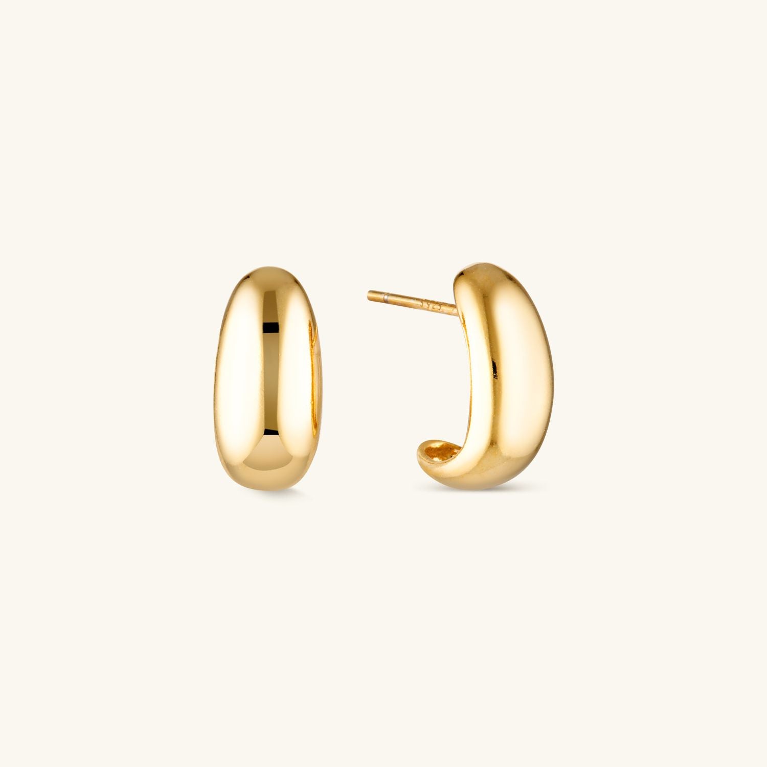 Large gold dome stud earrings with a bold, minimalist design. A statement accessory that adds elegance and modern sophistication to any outfit