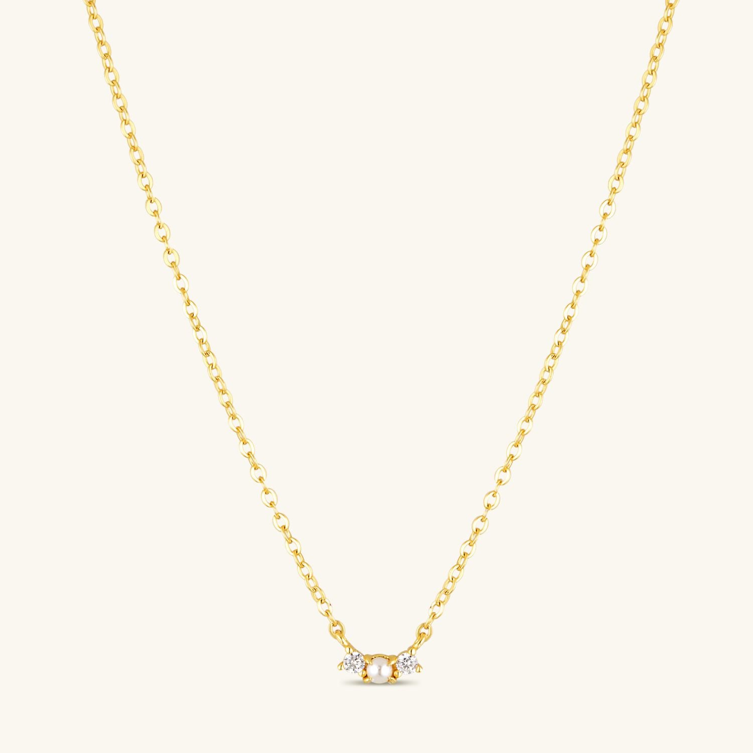 Necklace with fresh water pearl with cubic zirconia on each side, with a gold plated chain