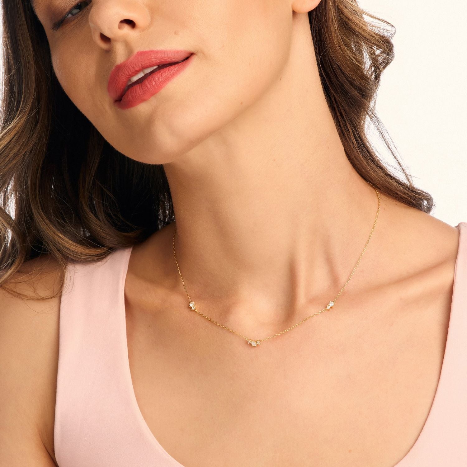Model wearing a floating cubic zirconia necklace on a delicate gold chain, showcasing its elegant, minimalist design and timeless sparkle