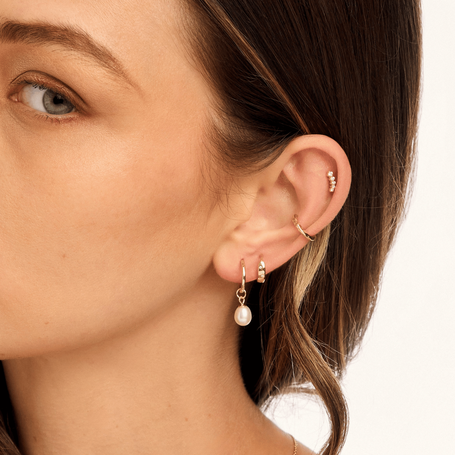 Model styled in gold freshwater pearl drop earrings, highlighting their refined beauty and classic sophistication for any occasion