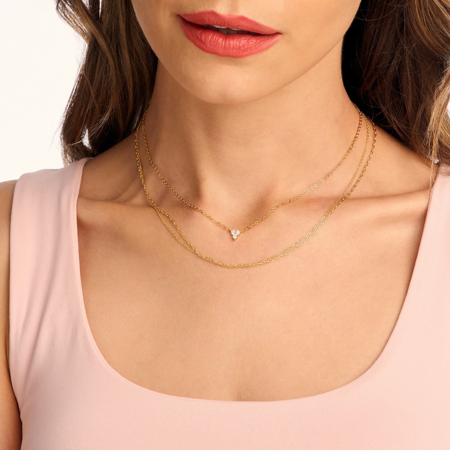 Model wearing a gold lotus flower necklace with sparkling cubic zirconia, showcasing its elegant design and symbolic beauty
