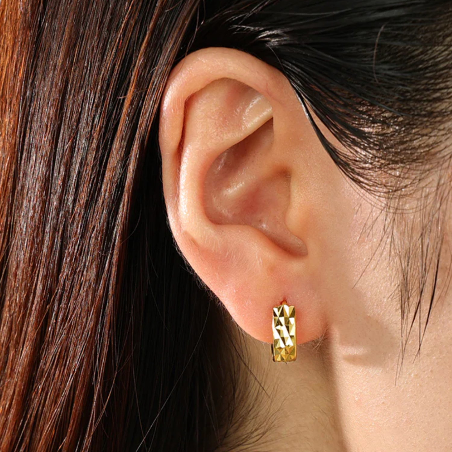 Model wearing textured huggie earring