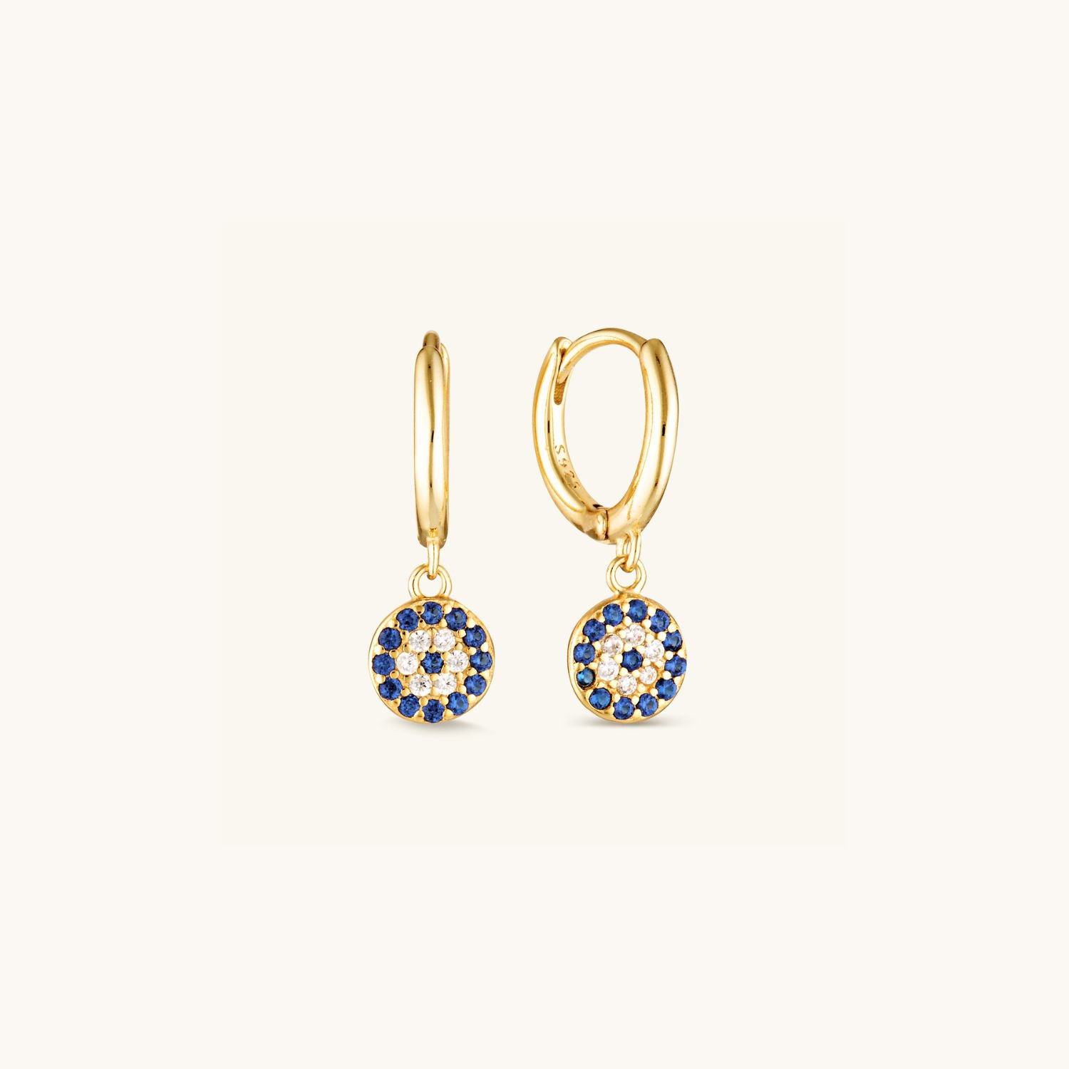 Gold huggie earrings with shimmering blue pavé stones and a modern drop design, offering bold colour and elegant style.