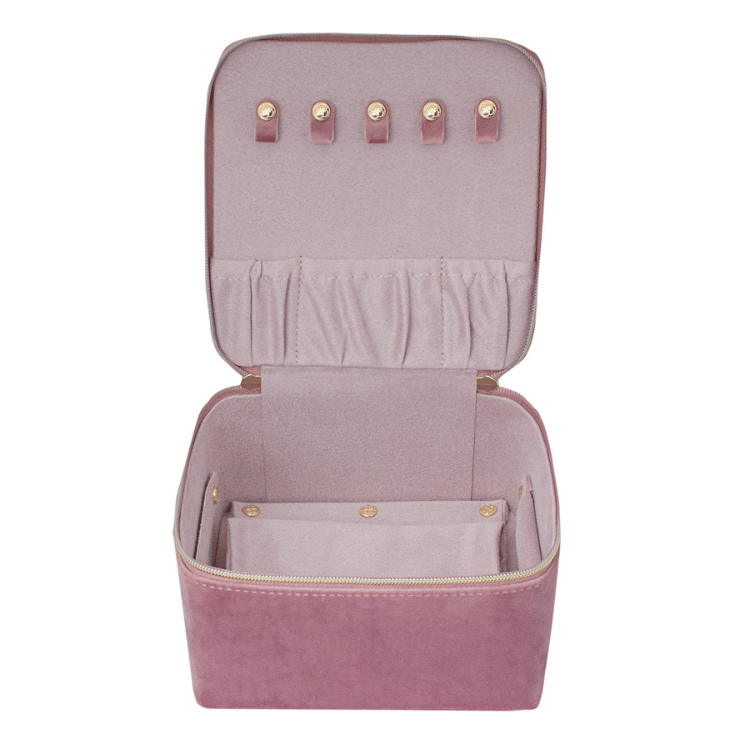 Open pink velvet jewellery box on a white background, revealing multiple compartments for organized jewellery storage.
