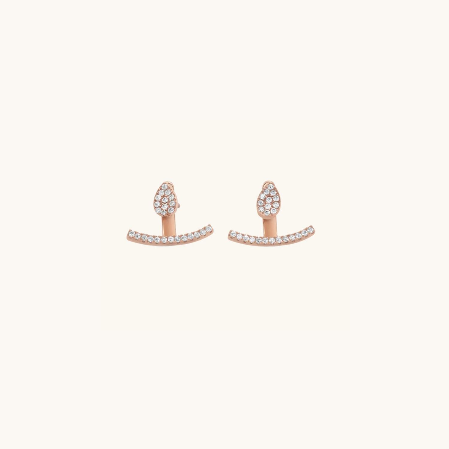 tear drop shaped stud earring in rose gold decorated with cubic zirconia with a cuff that sits below the lobe.