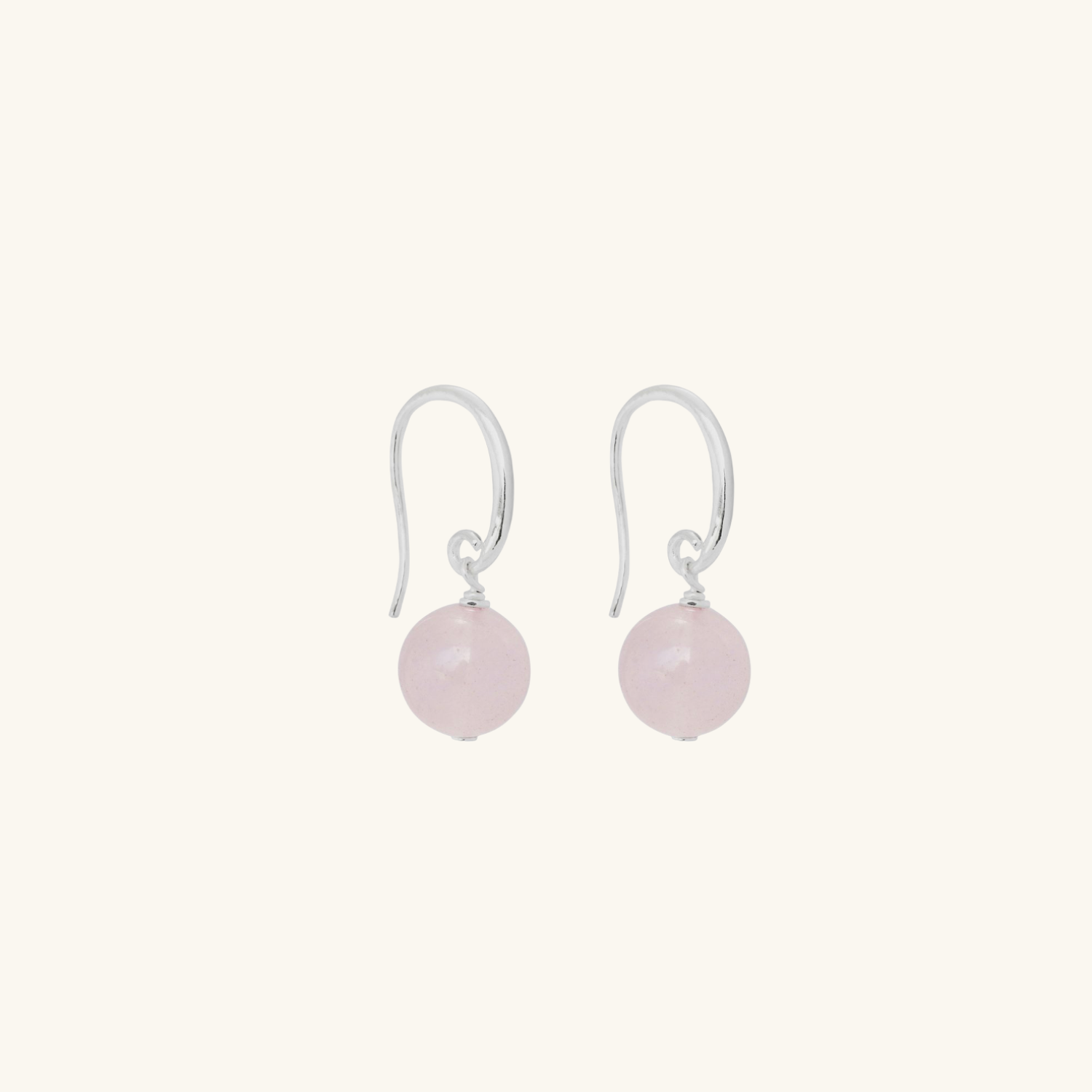 Pair of rose quartz round earrings on a white background
