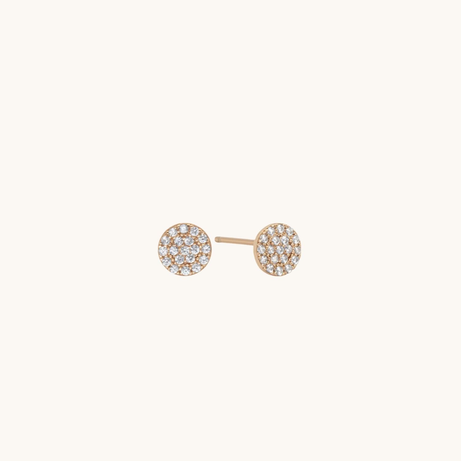 Pretty Rose gold plated cubic zirconia earrings displayed on a cream background