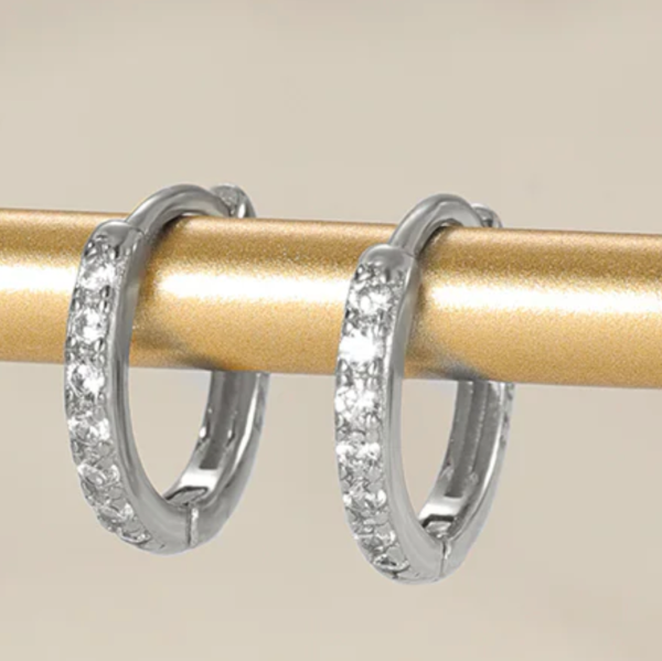 Silver CZ Huggies shown hanging on gold coloured bar