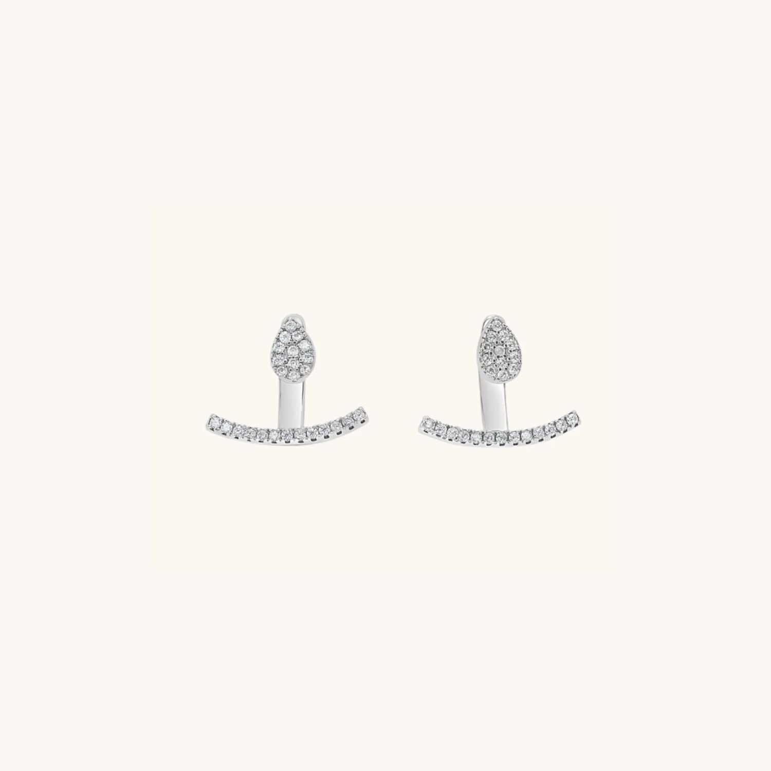 tear drop shaped stud earring in silver decorated with cubic zirconia with a cuff that sits below the lobe.