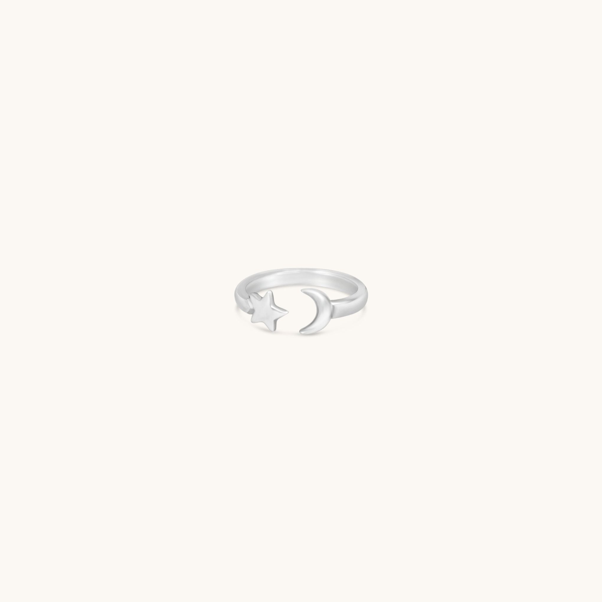 Silver ring with a moon design on a white background