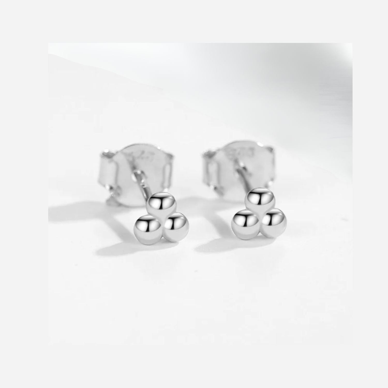 Silver three-ball cluster earrings with a modern, minimalist design. Sleek, stylish, and perfect for adding a touch of elegance to any outfit
