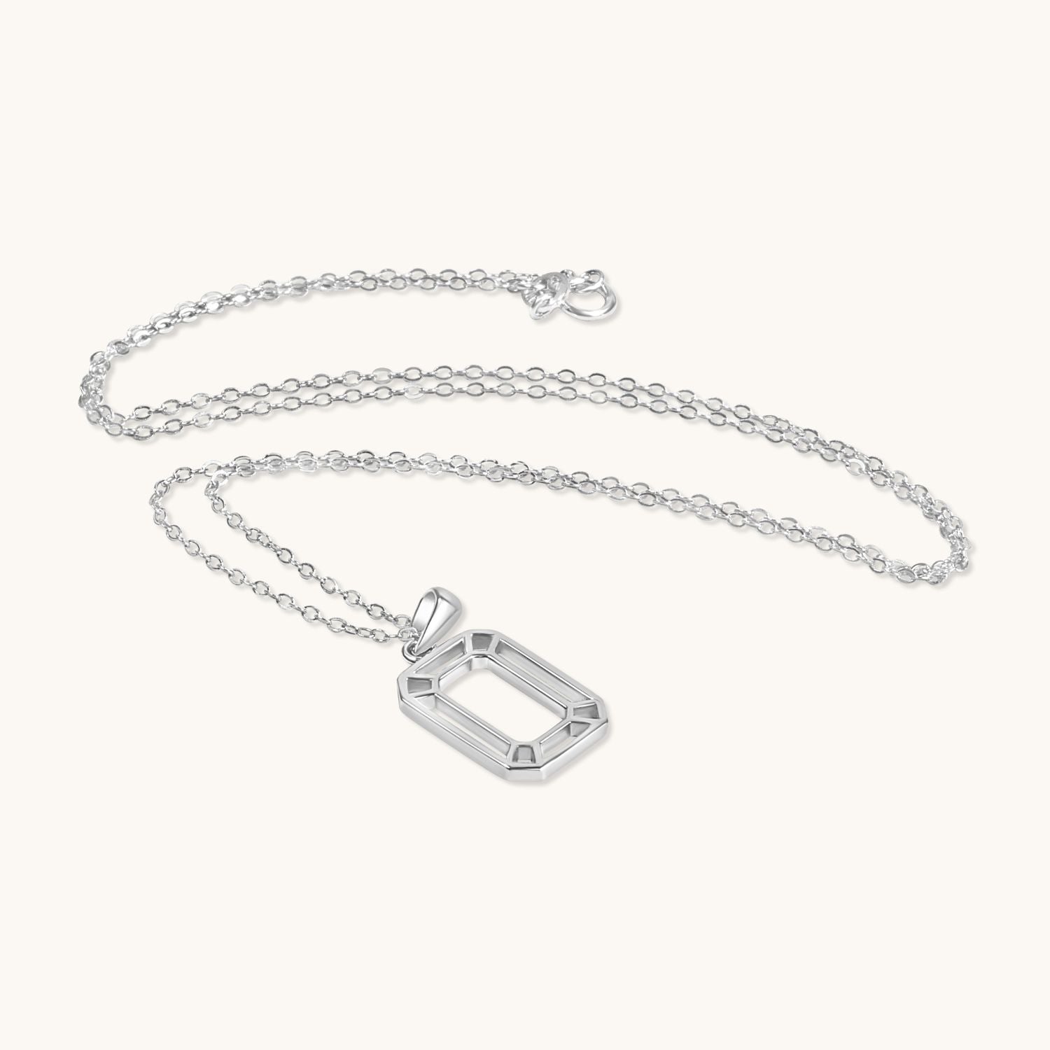 Silver interlocking box pendant necklace with a modern geometric design on a delicate chain. Stylish, timeless, and versatile.