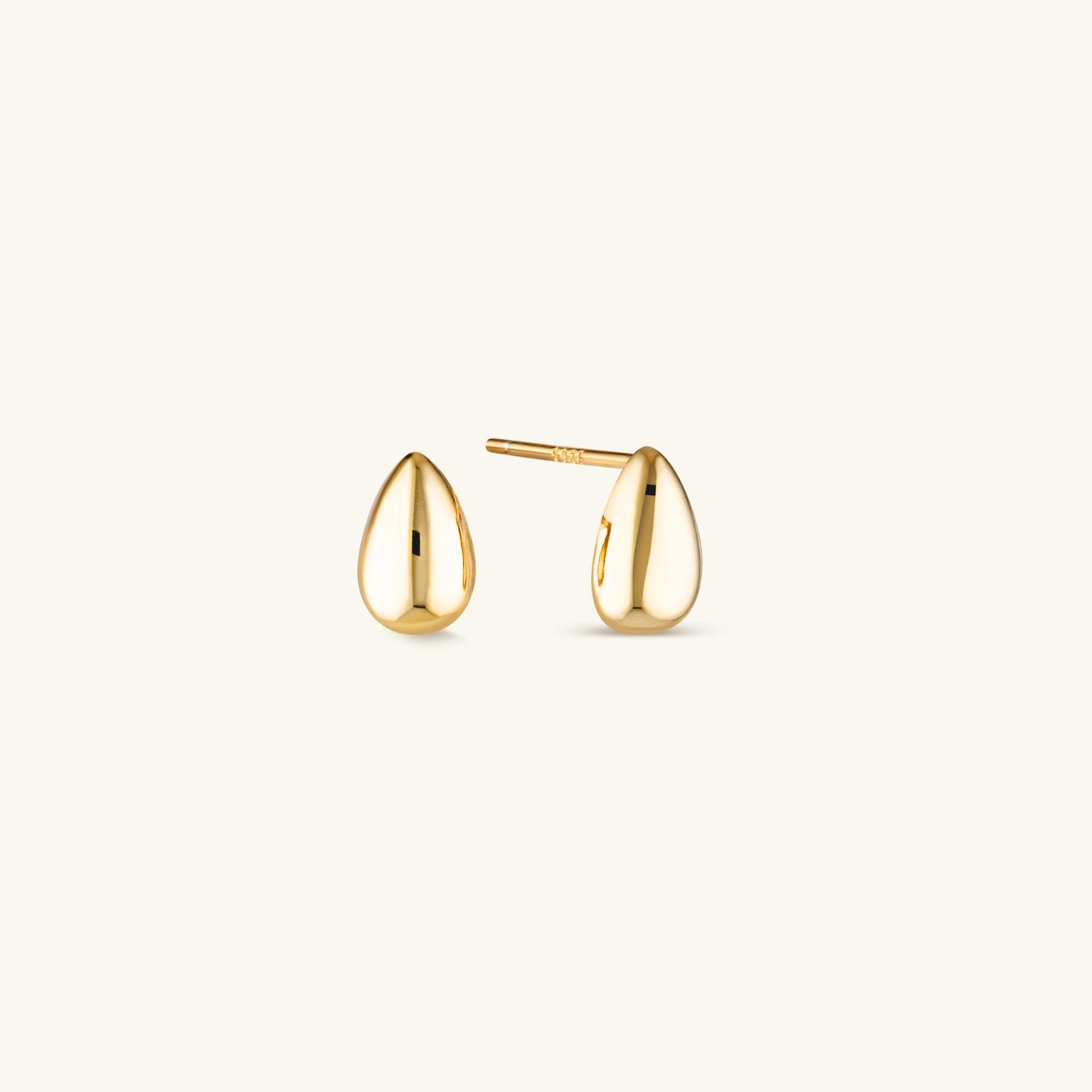 Small gold dome stud earrings with a sleek, minimalist design. Stylish and on-trend, perfect for everyday wear or layering with other pieces