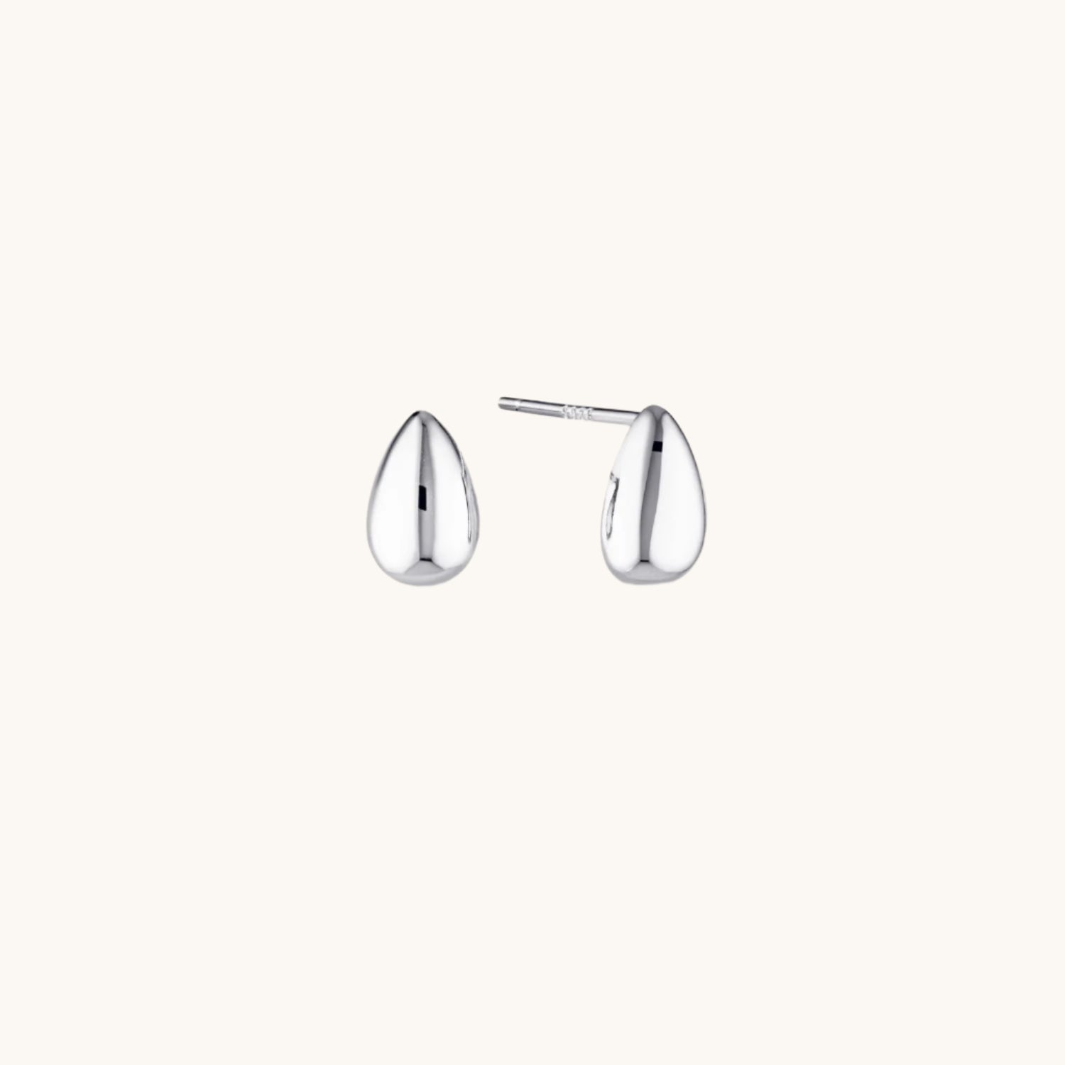 Small silver dome stud earrings with a sleek, minimalist design. Modern and on-trend, perfect for everyday wear or layering with other pieces