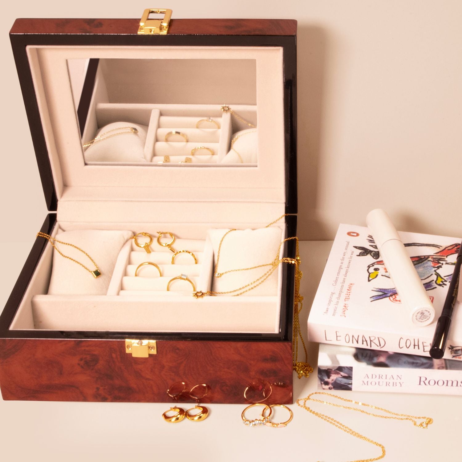 Wood finish jewellery box open with jewellery inside, highlighting soft lining, compartments, and an interior mirror