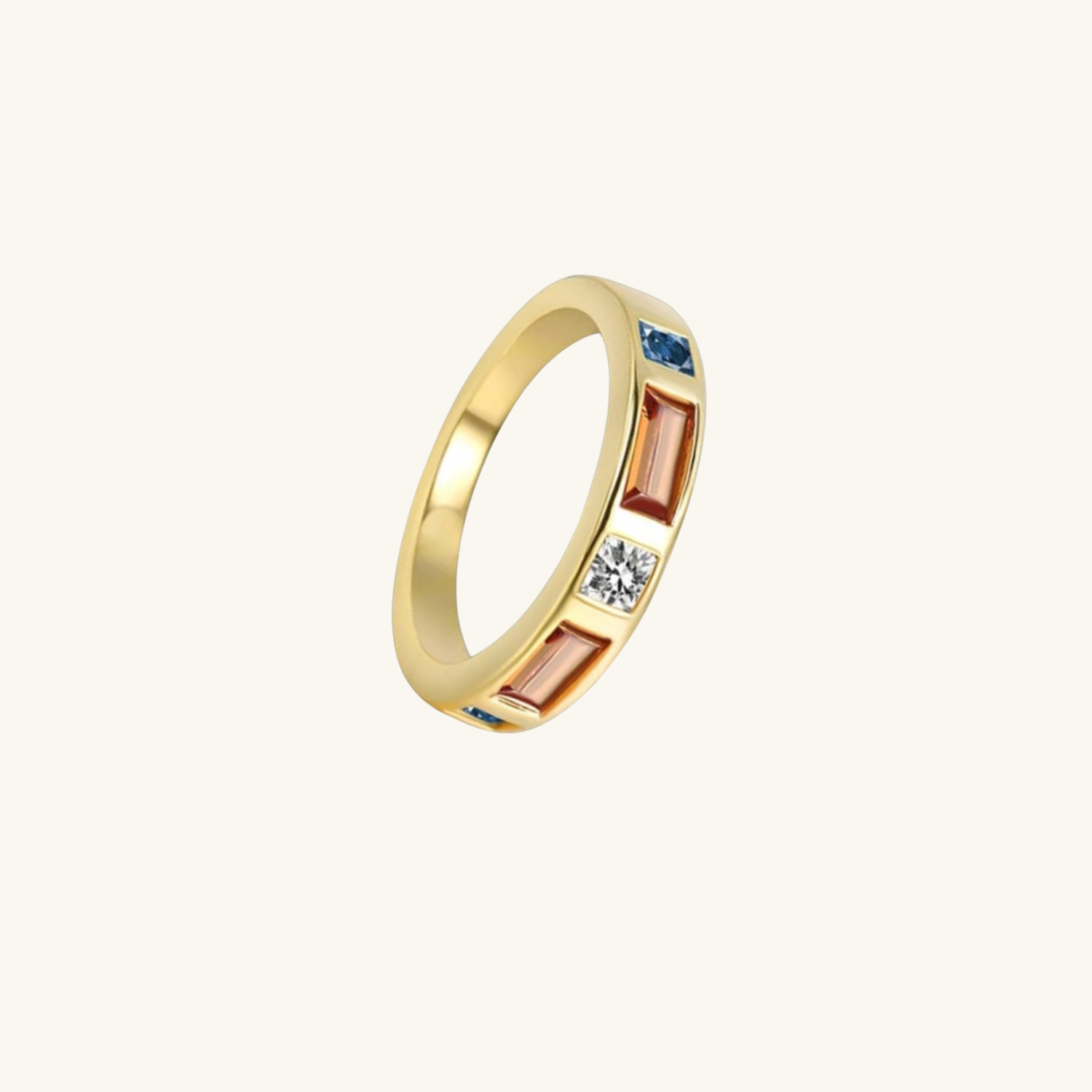 Gold ring with embedded gemstones on a white background