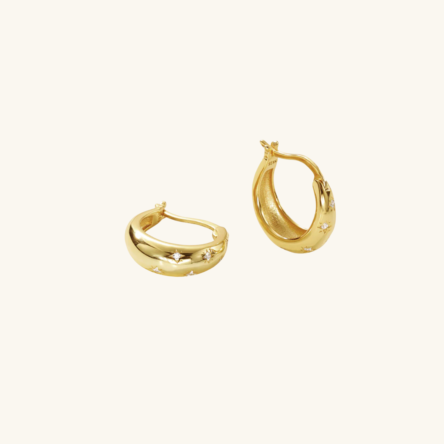 Gold hoop earrings on a white background