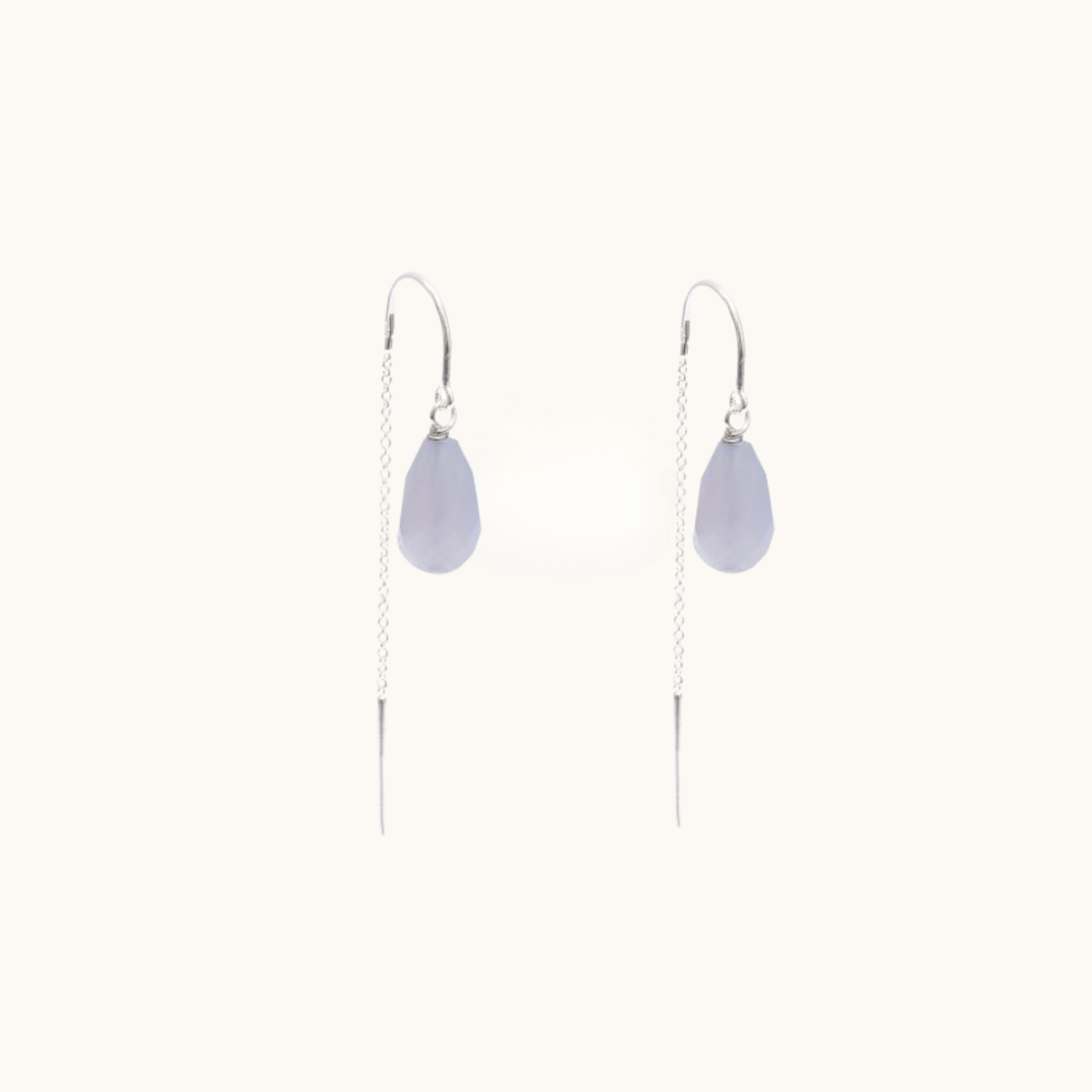 Pair of silver thread earrings on a white background