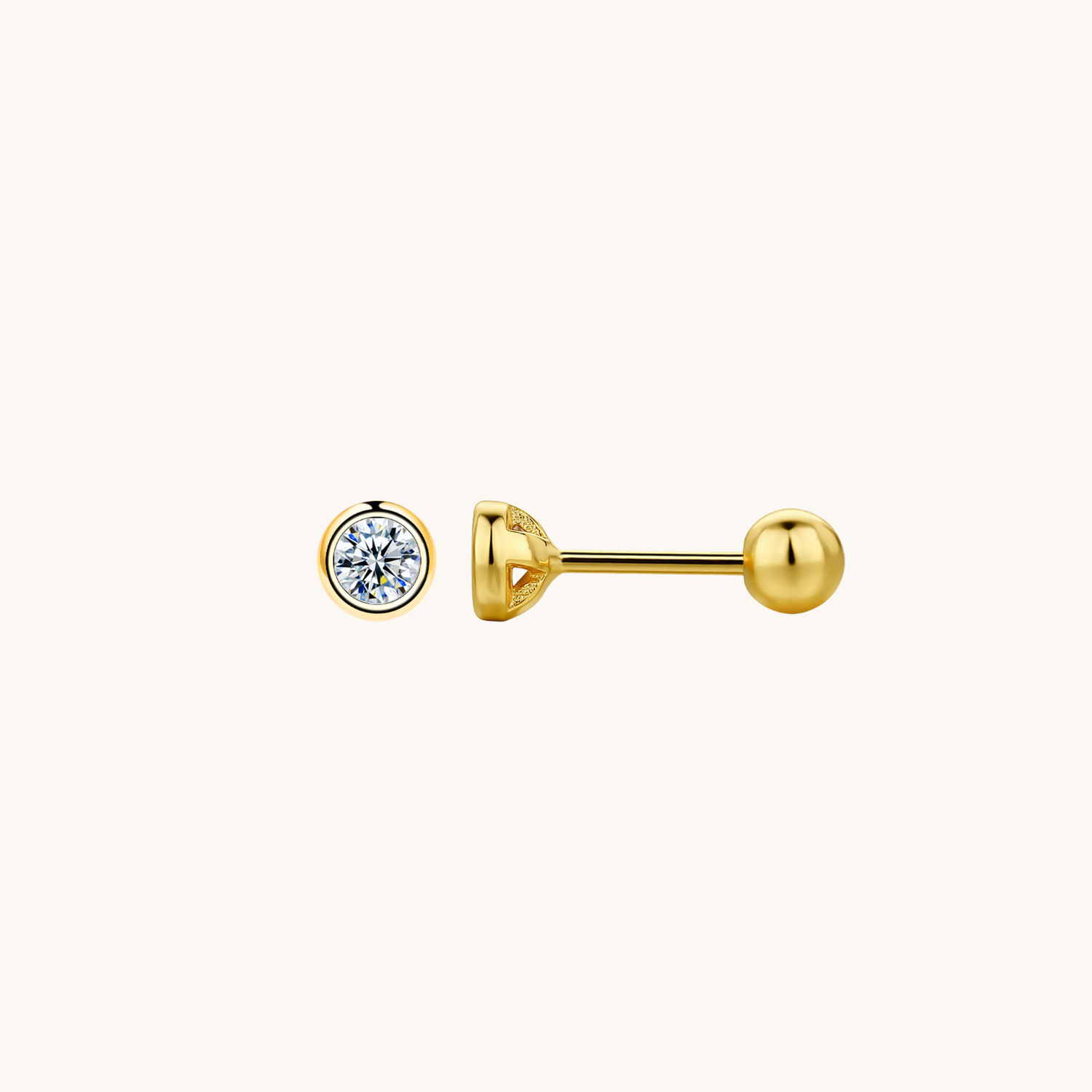 A gold barbell stud earring shown from two angles: a front view featuring a round bezel-set clear gemstone, and a side profile view showing the ball back. The earring is photographed on a clean, solid off-white background.