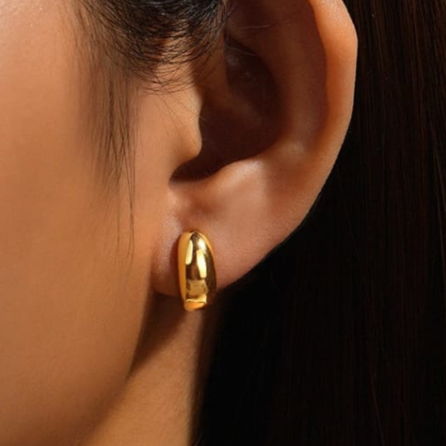 model_wearing_large_dome_earring