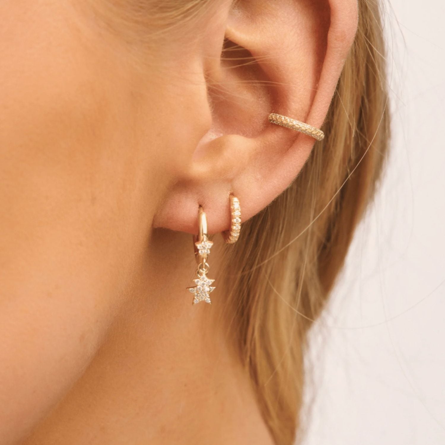 Model wearing classic cubic zirconia huggie earrings, showcasing their timeless sparkle and elegant, everyday style