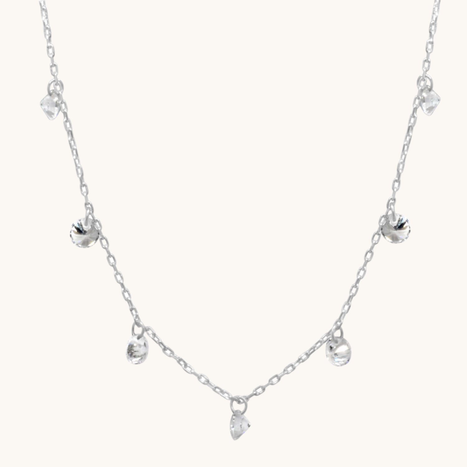Pretty Cubic Zirconia Drop silver Necklace  pictured on warm cream background