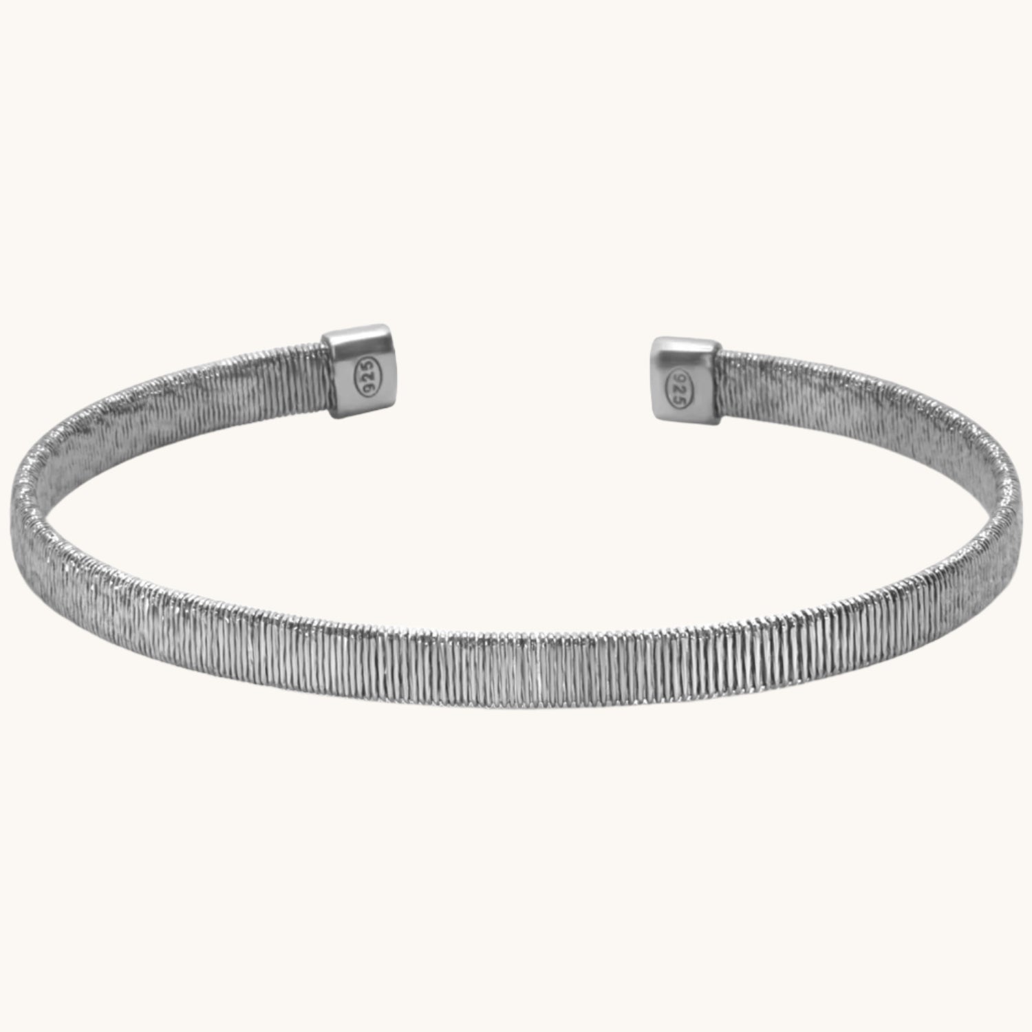 Thick diamond-cut textured bangle with shimmering facets, styled against a neutral background.