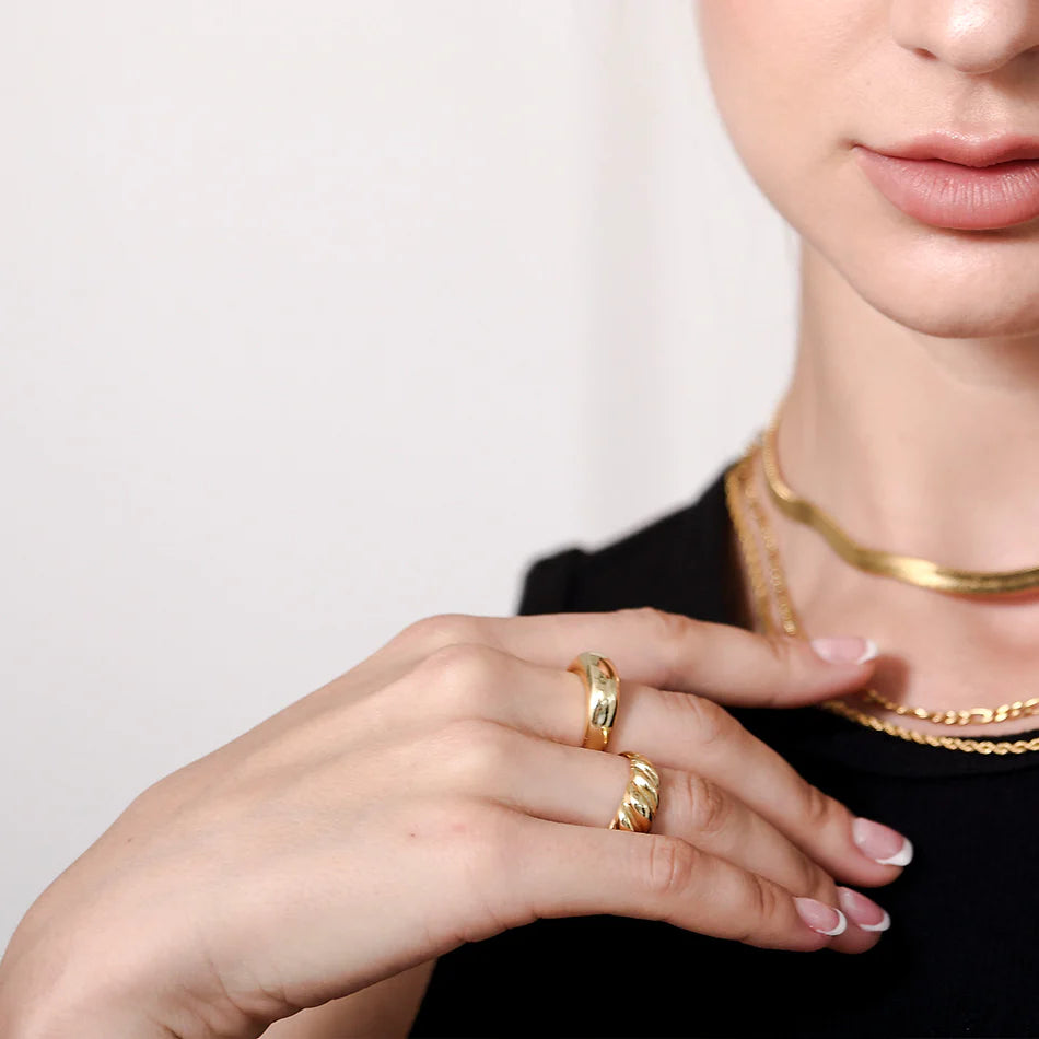 Model with gold croissant dome ring