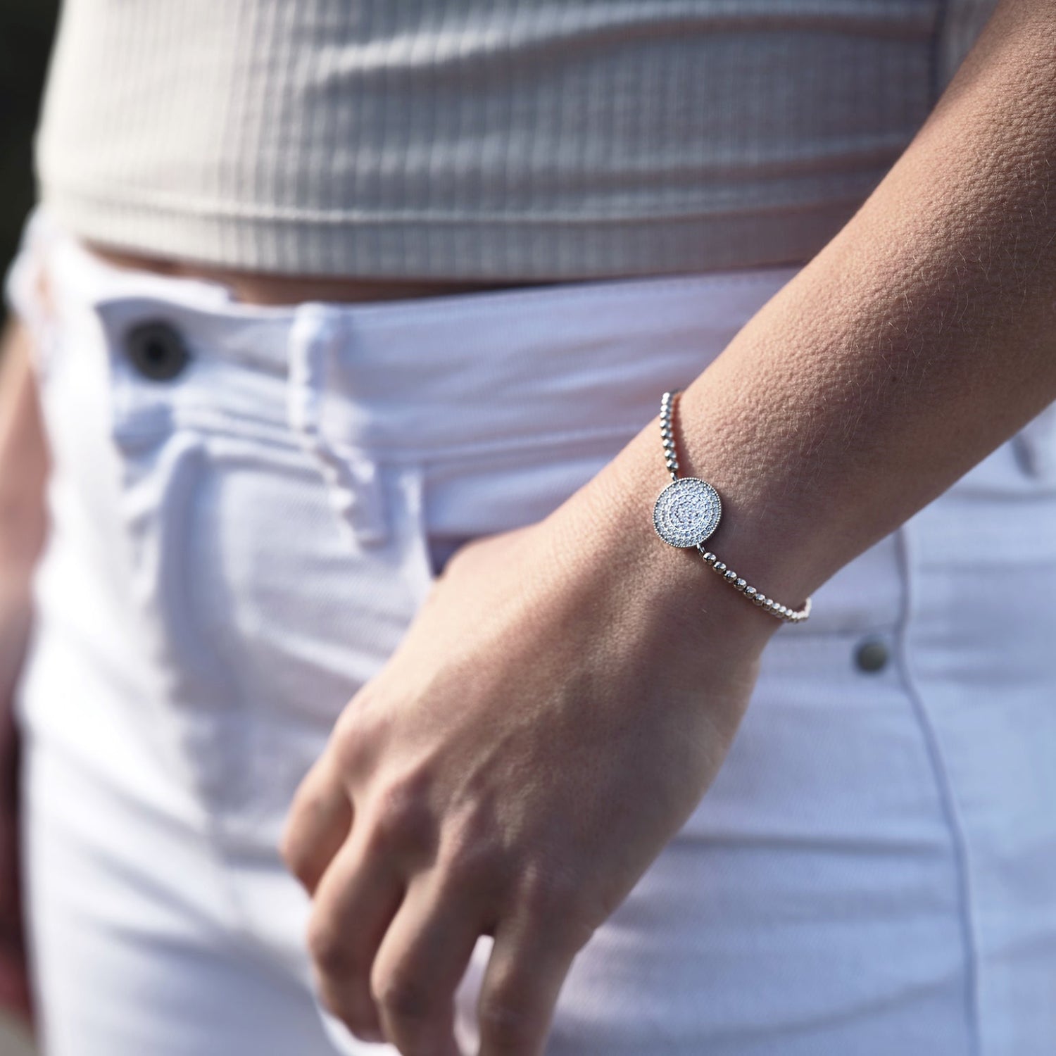 model wears bead bracelet with pave crystals