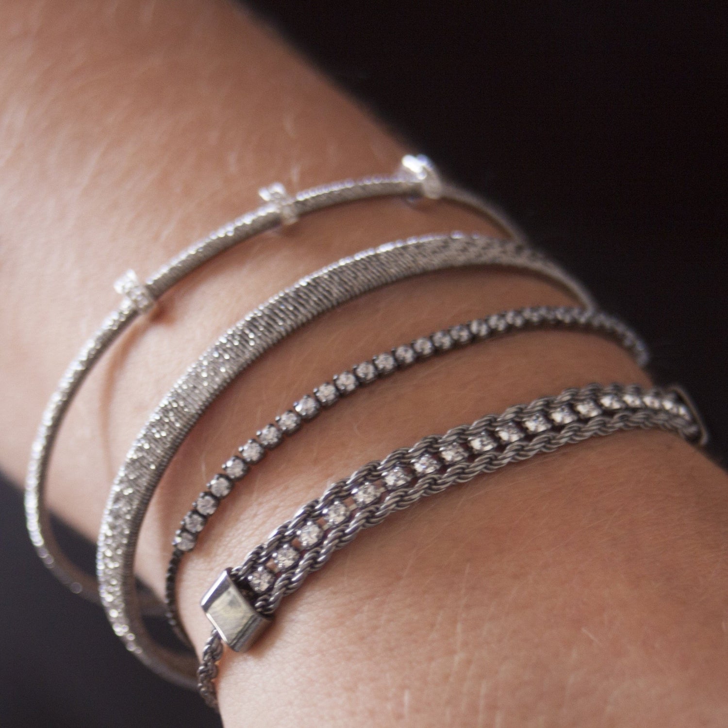 model wears diamond cut silver bangle stacked with three others from the I Dream of Silver collection