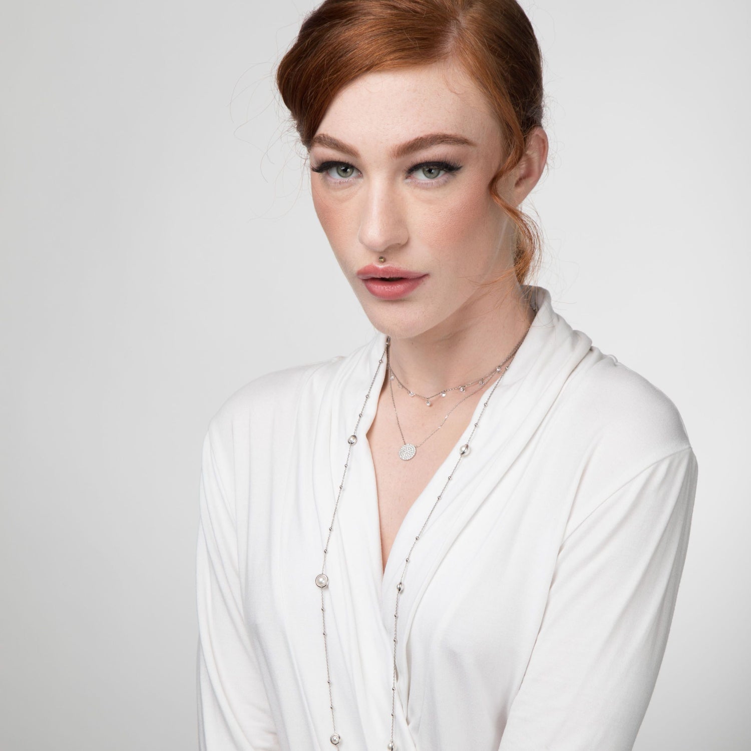 Model wearing Pearl-Encased Bauble-Chain Necklace, layered with other silver necklaces