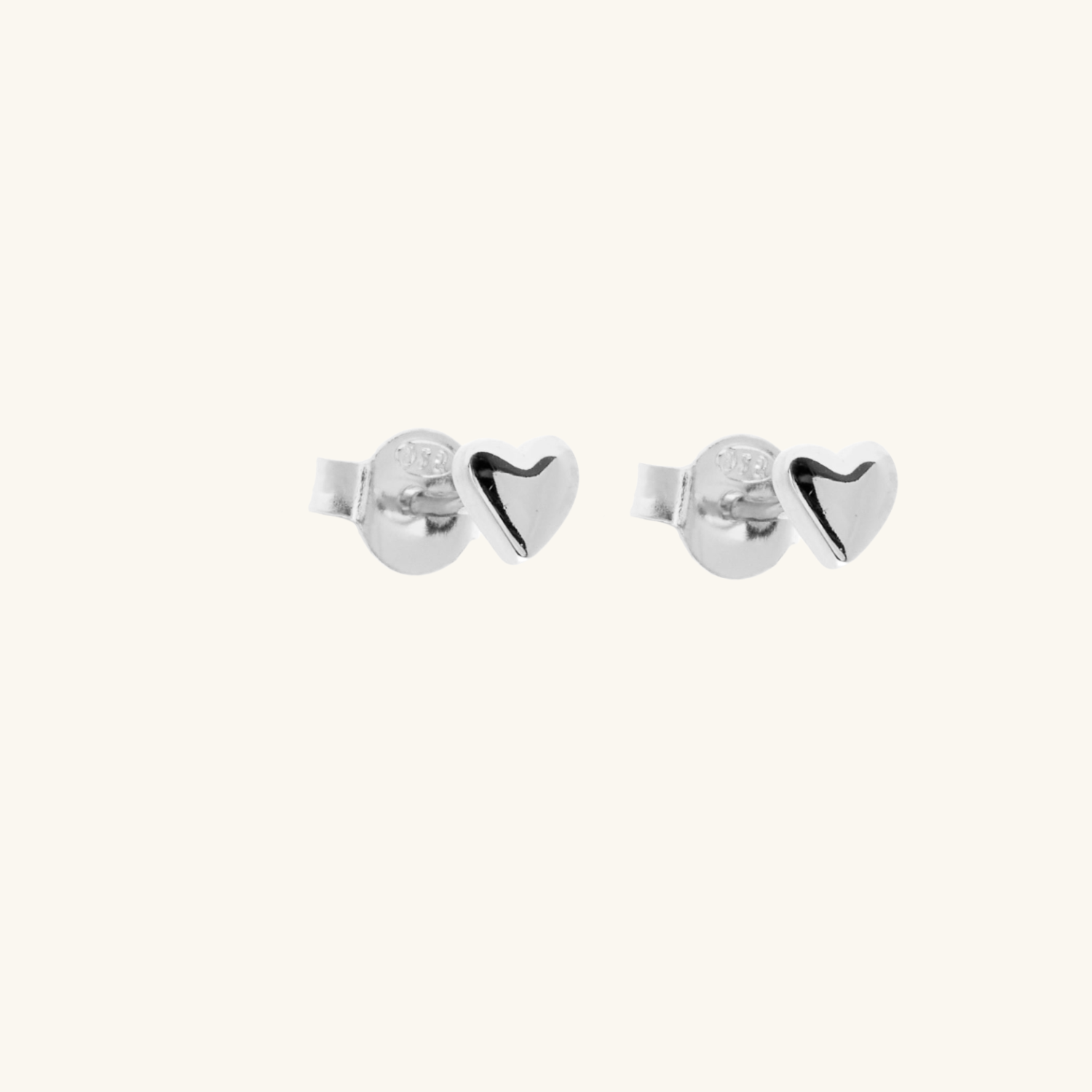 Pair of silver heart-shaped earrings on a white background