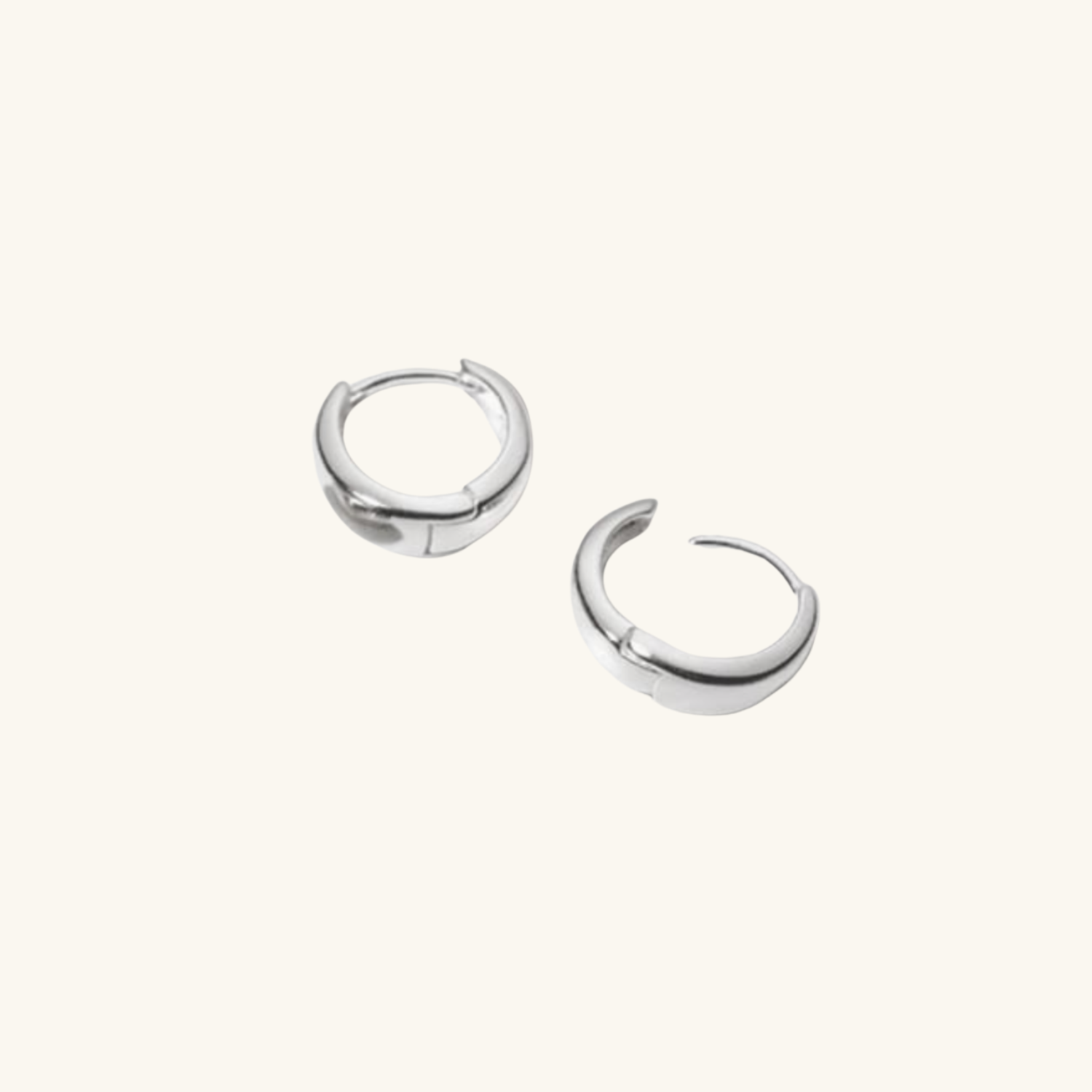 Pair of silver hoop earrings on a white background