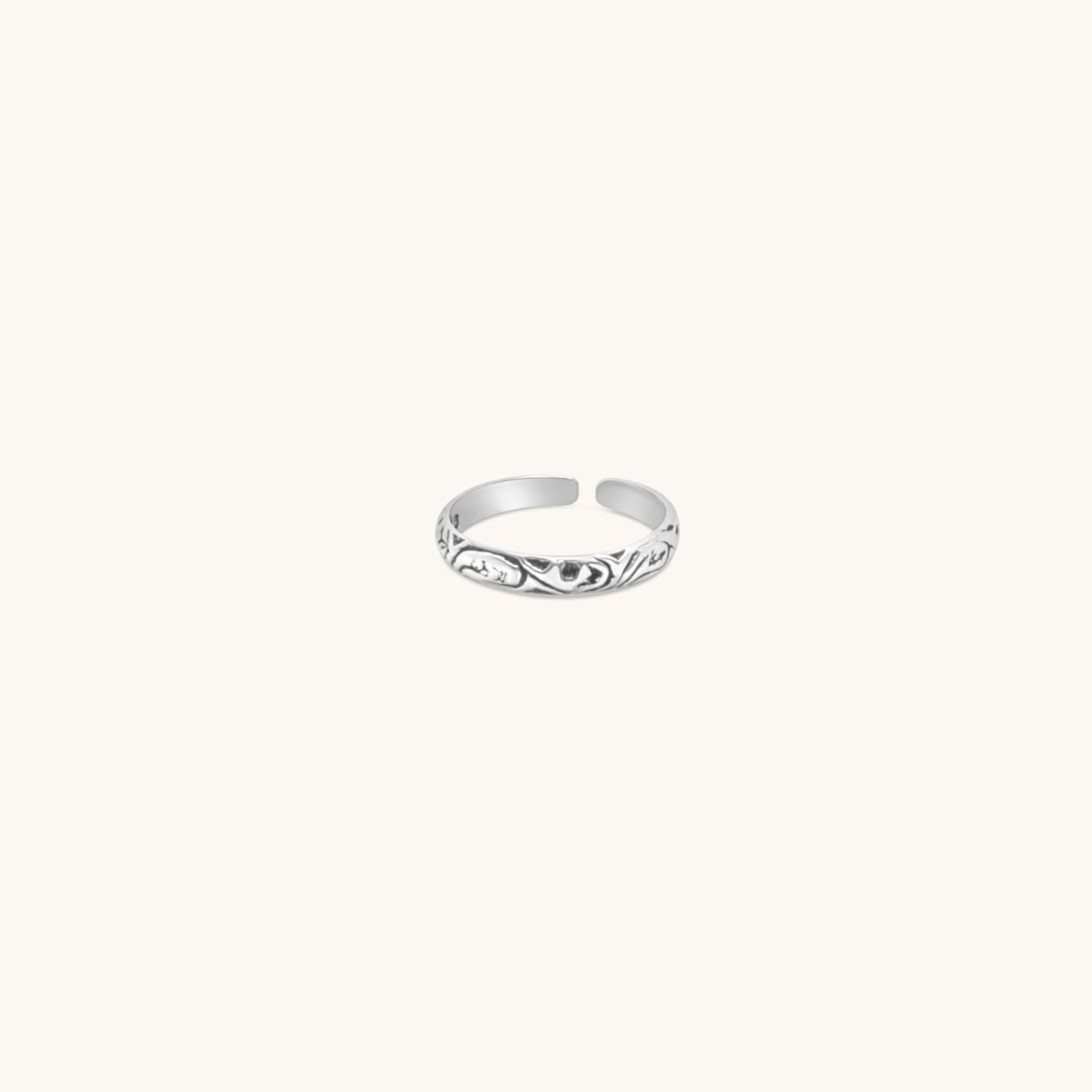 Sterling silver adjustable toe ring with a decorative pattern.