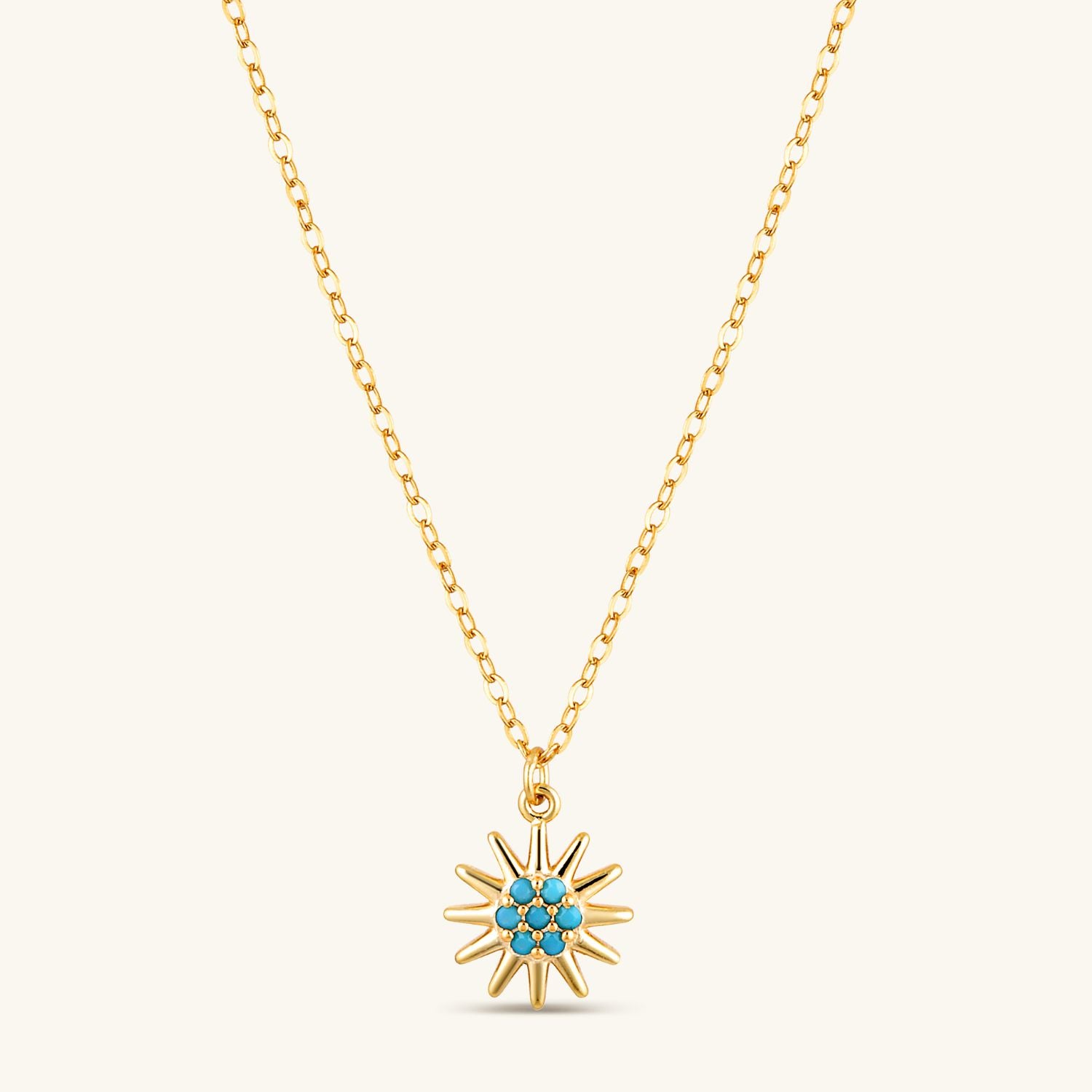 Blue azure sun necklace on warm cream background