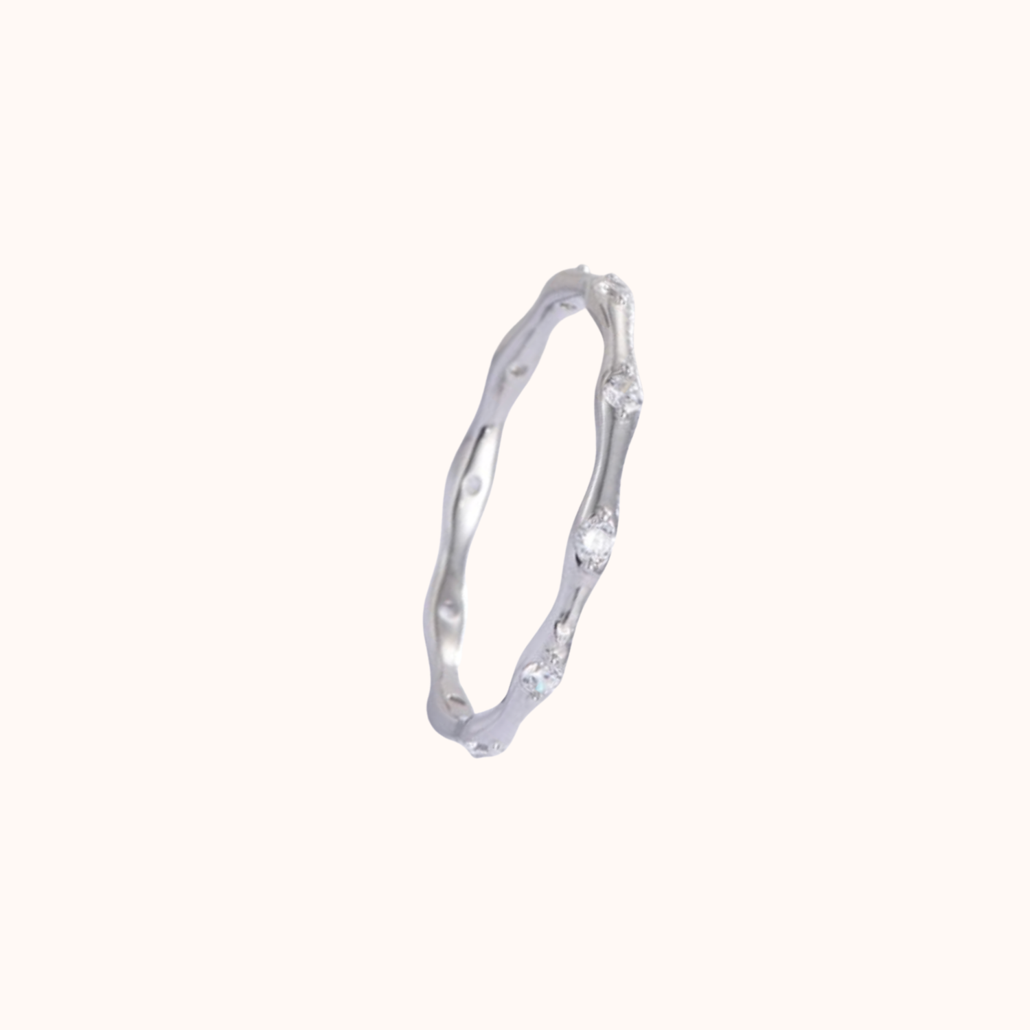 Silver ring with a subtle design on a white background